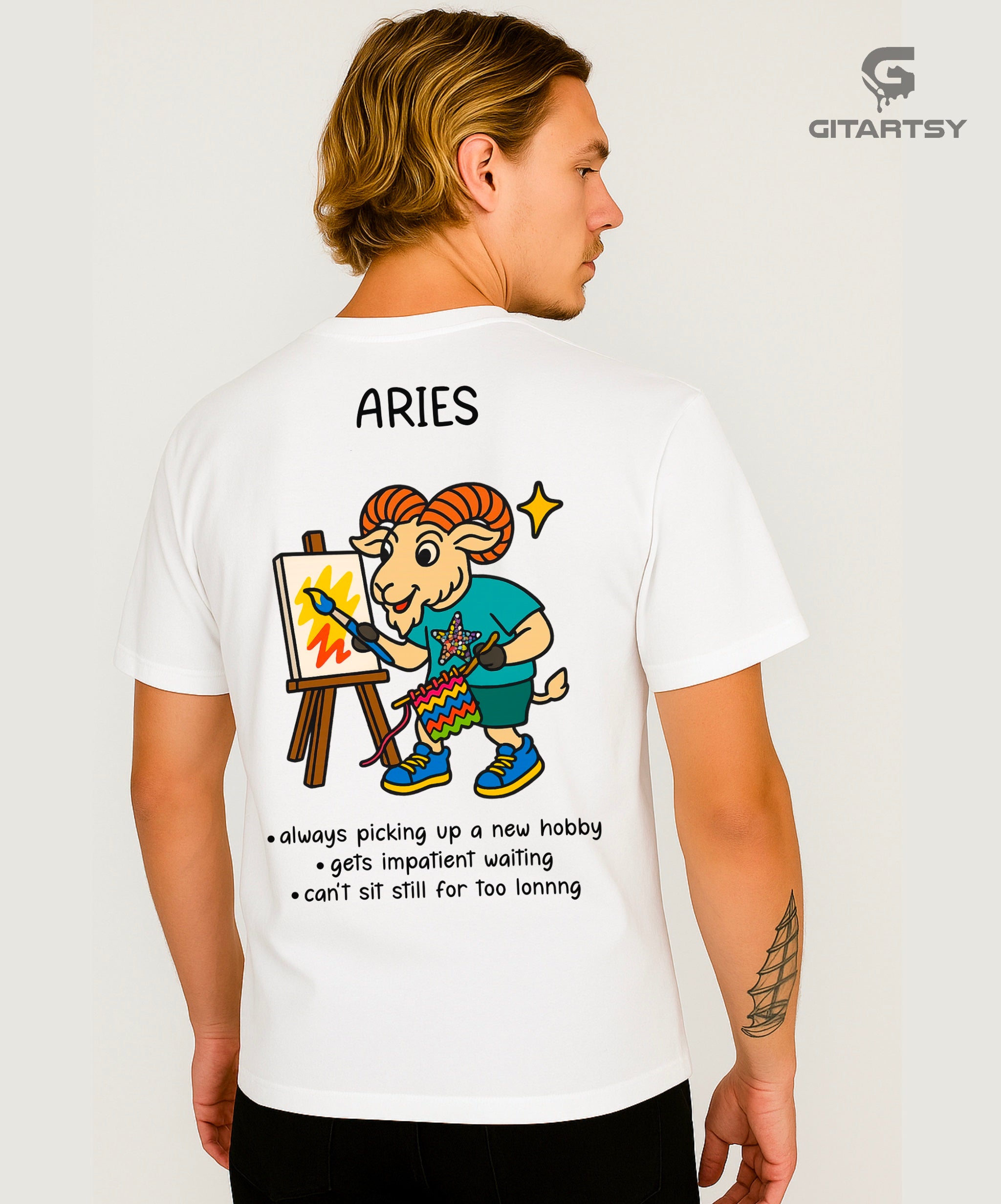Aries Zodiac Sign T-Shirt – Funny, Bold & Minimal Streetwear Tee (Unisex) white. Features a Ram painting a canvas and knitting at the same time.