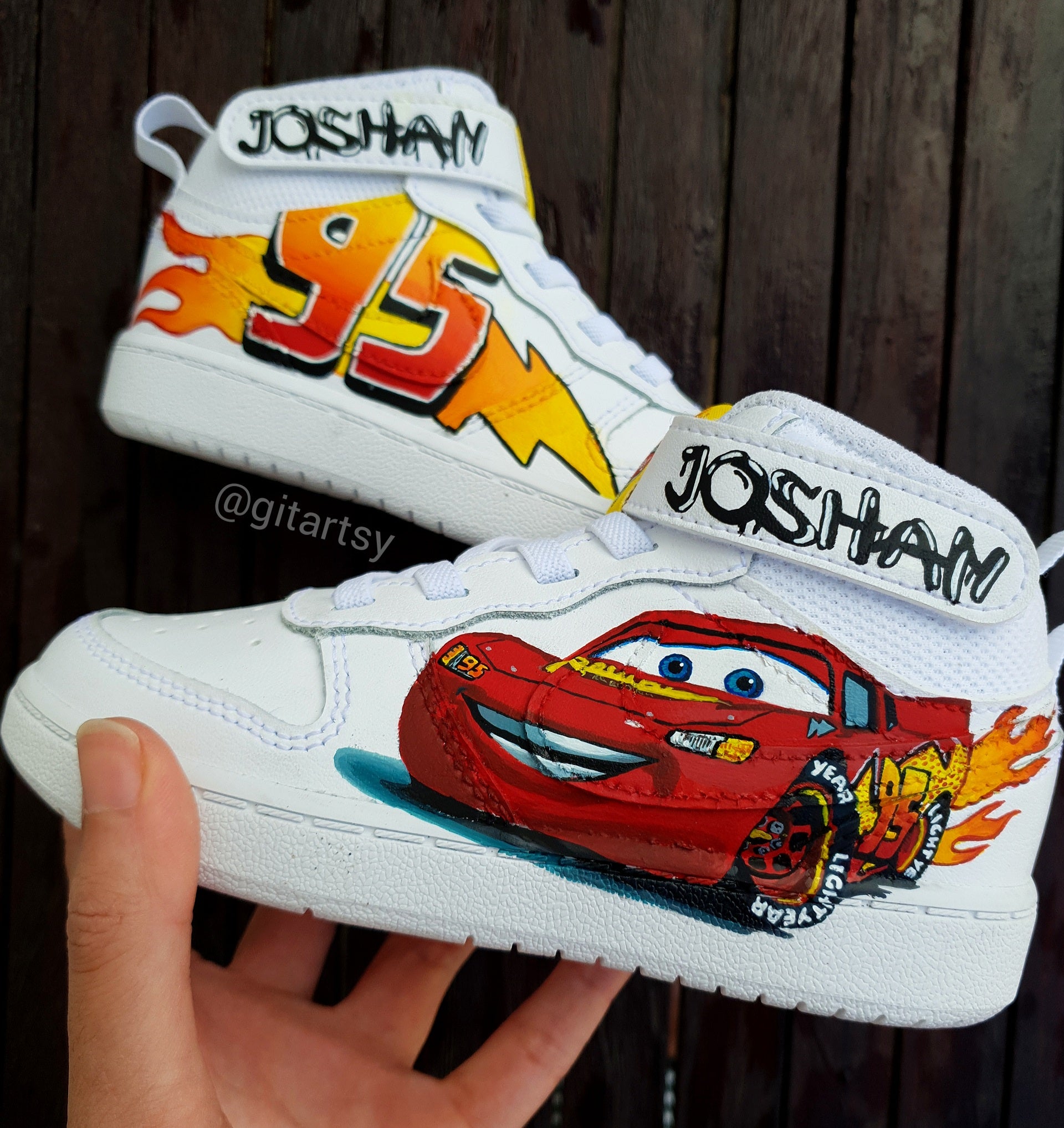 Custom hand-painted Nike sneakers for kids inspired by the Cars movie character Lightning McQueen. Features detailed artwork of the red race car, “95” lightning bolt graphics, and bright flame motifs, all sealed on genuine Nike shoes. Personalized with the child’s name, each pair is a unique, handcrafted tribute to speed and imagination. Durable, waterproof, and safe for everyday toddler wear. Perfect gift or collectible for any young fan of the beloved movie character.