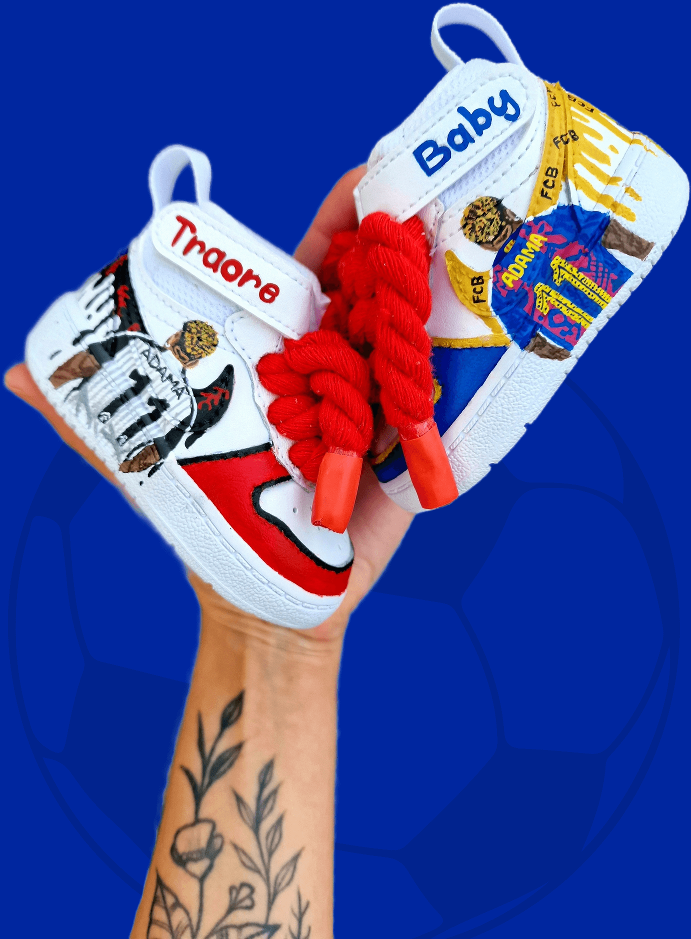 Custom hand-painted baby sneakers inspired by footballer Adama Traoré, featuring FC Barcelona and Fulham FC themes, complete with team logos, jersey illustrations, red braided laces, and personalized strap names on a white baby shoe base.