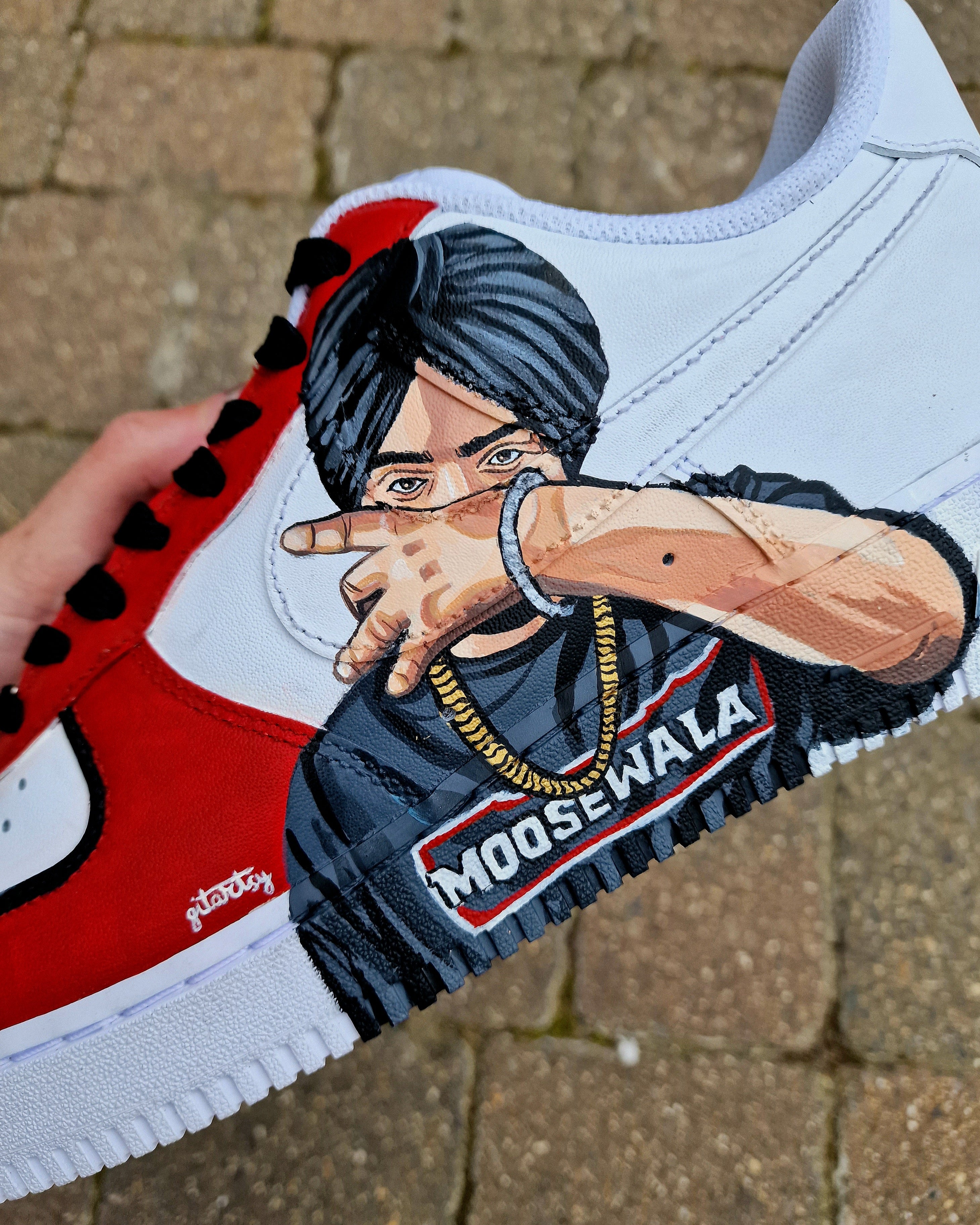 Hand-painted Sidhu Moosewala portrait sneakers – Nike AF1 tribute in black and red. Tribute sneaker art – realistic Sidhu Moosewala on leather sneakers