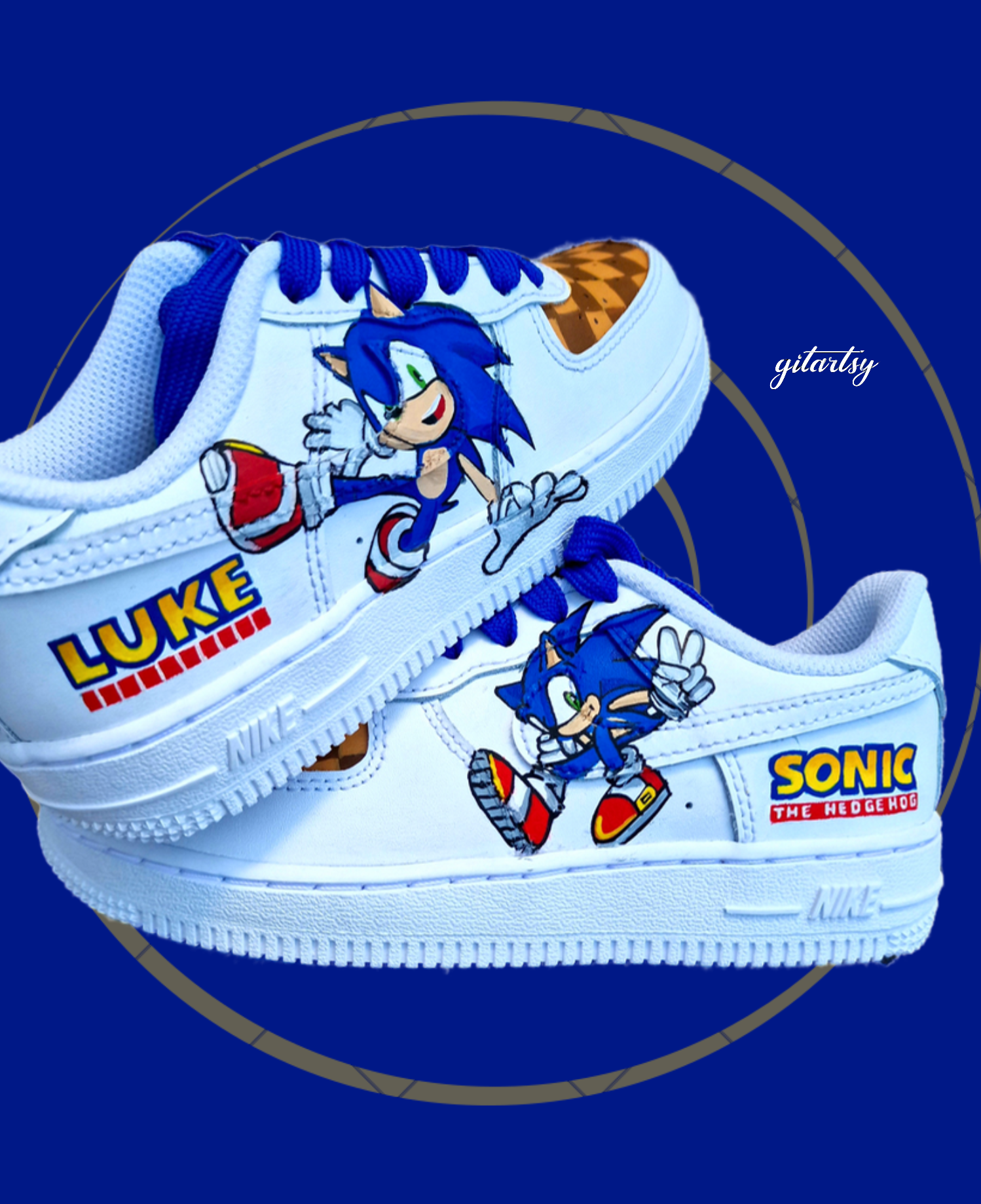 Custom white Nike Air Force 1 kids sneakers featuring vibrant hand-painted Sonic the Hedgehog character artwork on the sides, personalized heel name "Luke", blue laces, and brown checkered patterns inspired by Sonic’s Green Hill Zone, designed by Gitartsy.
