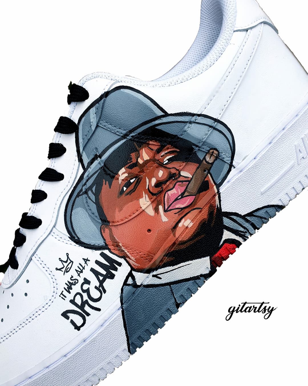 Custom hand-painted Nike Air Force 1 sneakers featuring vivid portraits of Tupac Shakur and The Notorious B.I.G. Designed by Gitartsy, these one-of-a-kind sneakers highlight Tupac's "Makaveli" persona and Biggie’s classic lyric “It Was All A Dream,” detailed with waterproof paint on genuine leather. A bold fusion of streetwear and tribute art, perfect for collectors and hip-hop fans.