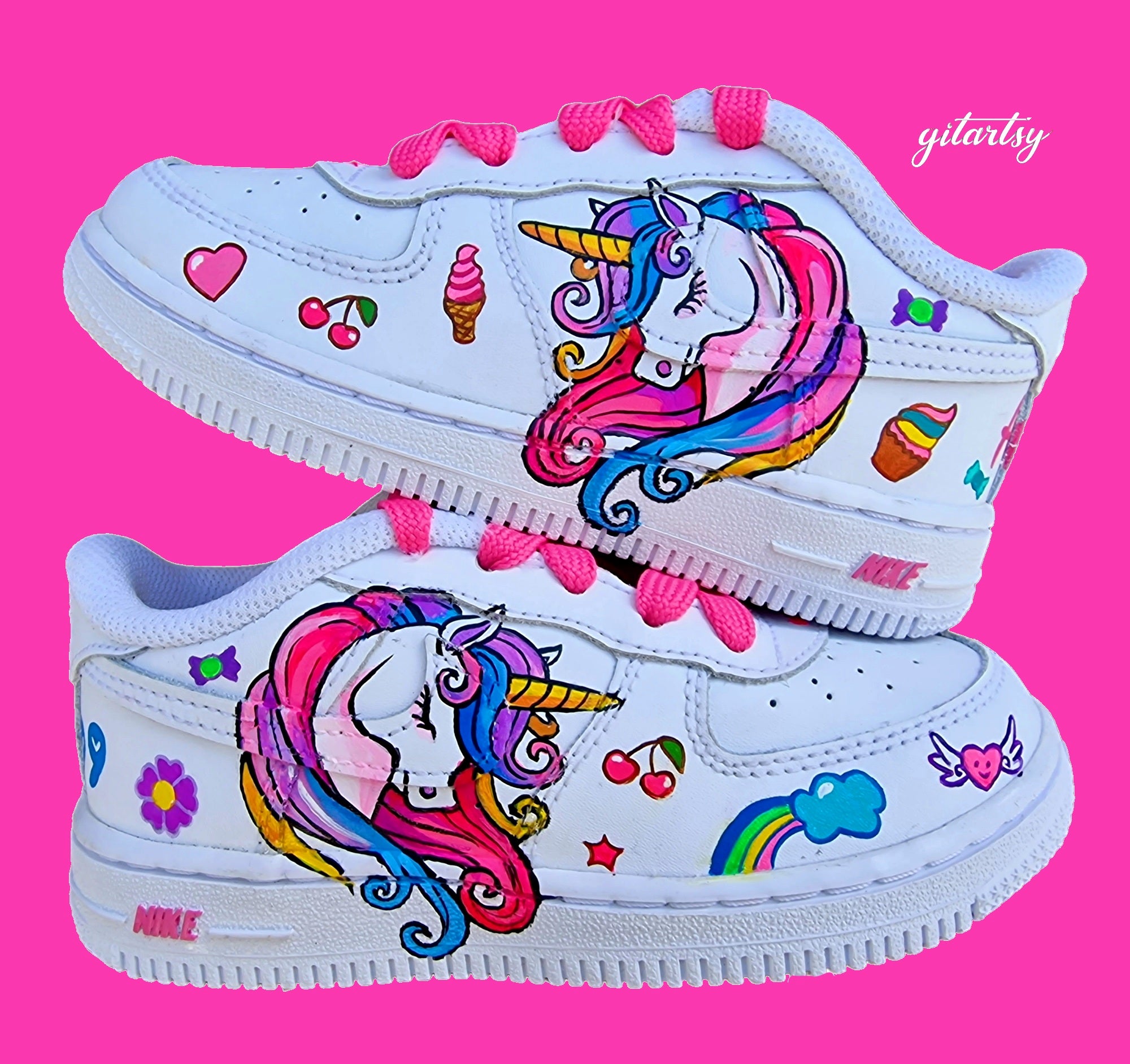 Custom hand-painted Nike kids sneakers with a whimsical unicorn design in rainbow colors, cherries, ice cream, hearts, and cute accents. Each pair features the child’s name and birthdate or special date painted on the back heel, with bright pink laces for added charm. Perfect personalised gift for birthdays, baby showers, or everyday wear for girls who love unicorns.