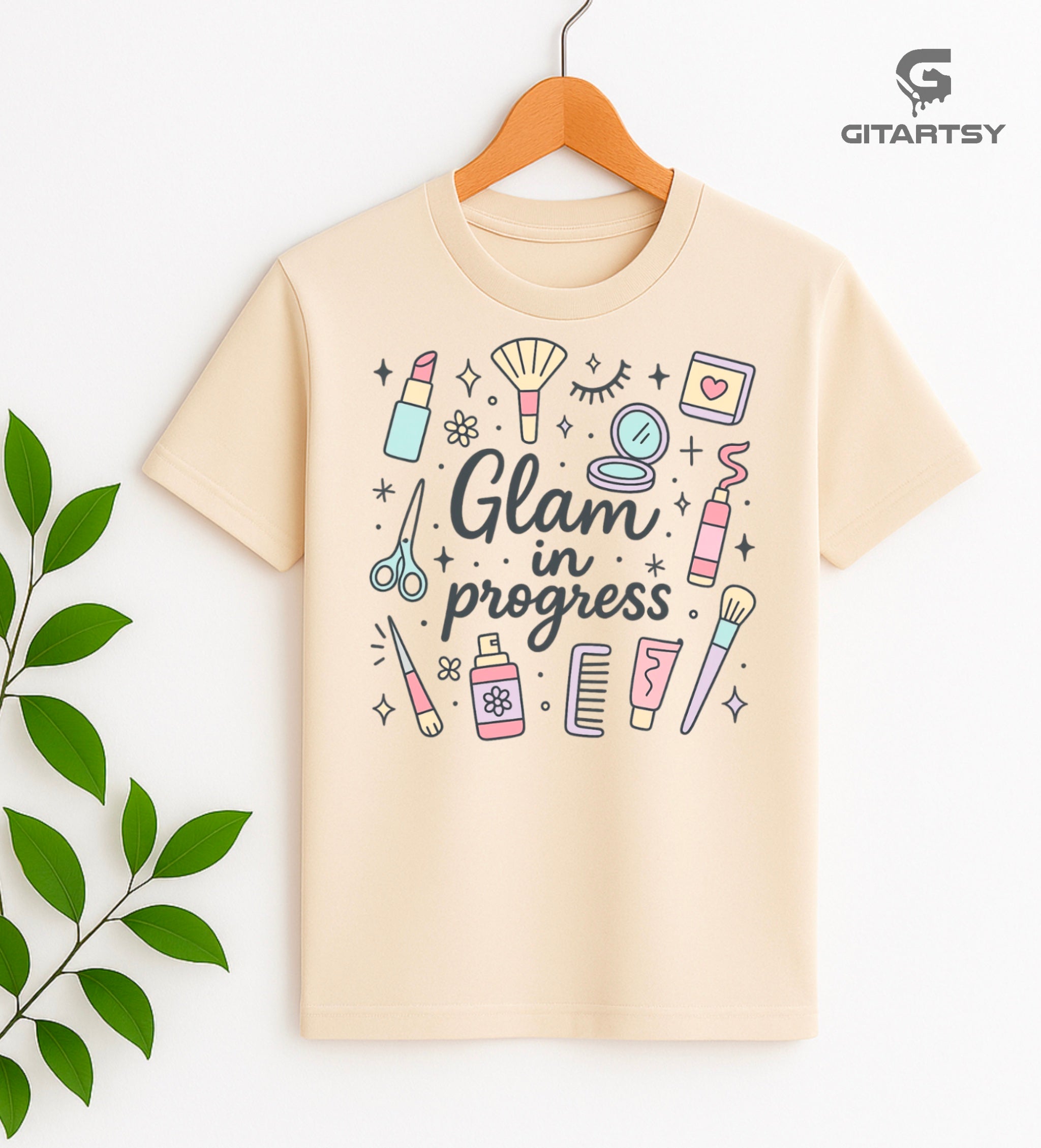 T-shirt featuring pastel makeup illustrations and the phrase “Glam in Progress” – perfect for makeup artists and beauty professionals.