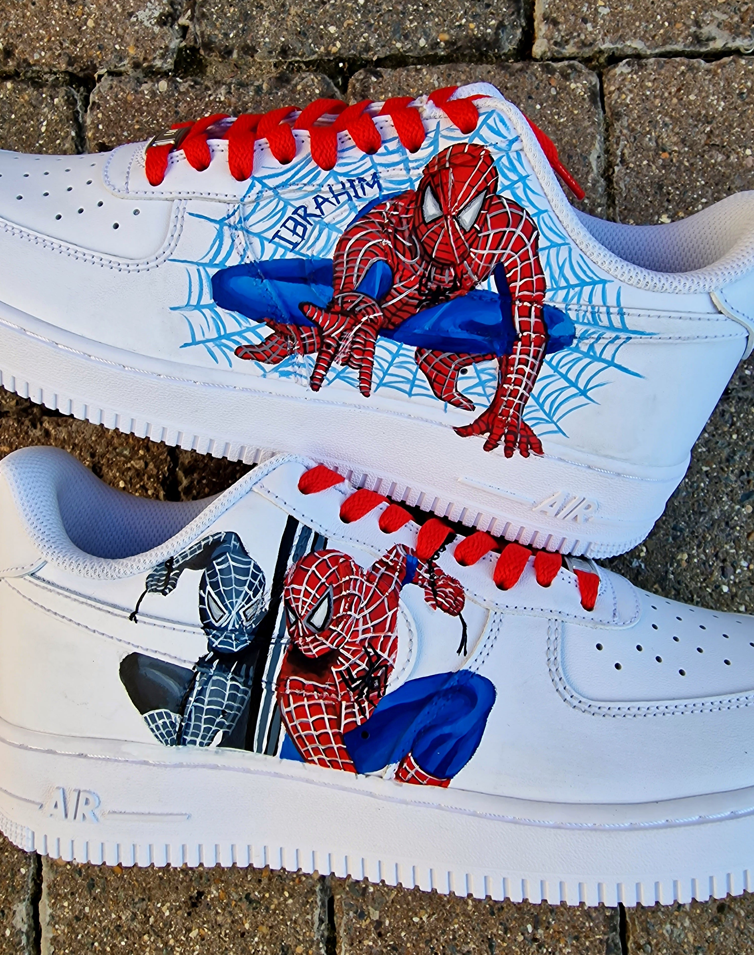 "Custom hand-painted Spider-Man Nike Air Force 1 sneakers featuring red and blue Spider-Man artwork, detailed spiderweb illustrations, customized name lettering, red laces, and color-themed Nike swooshes. Personalized superhero sneakers by Gitartsy."