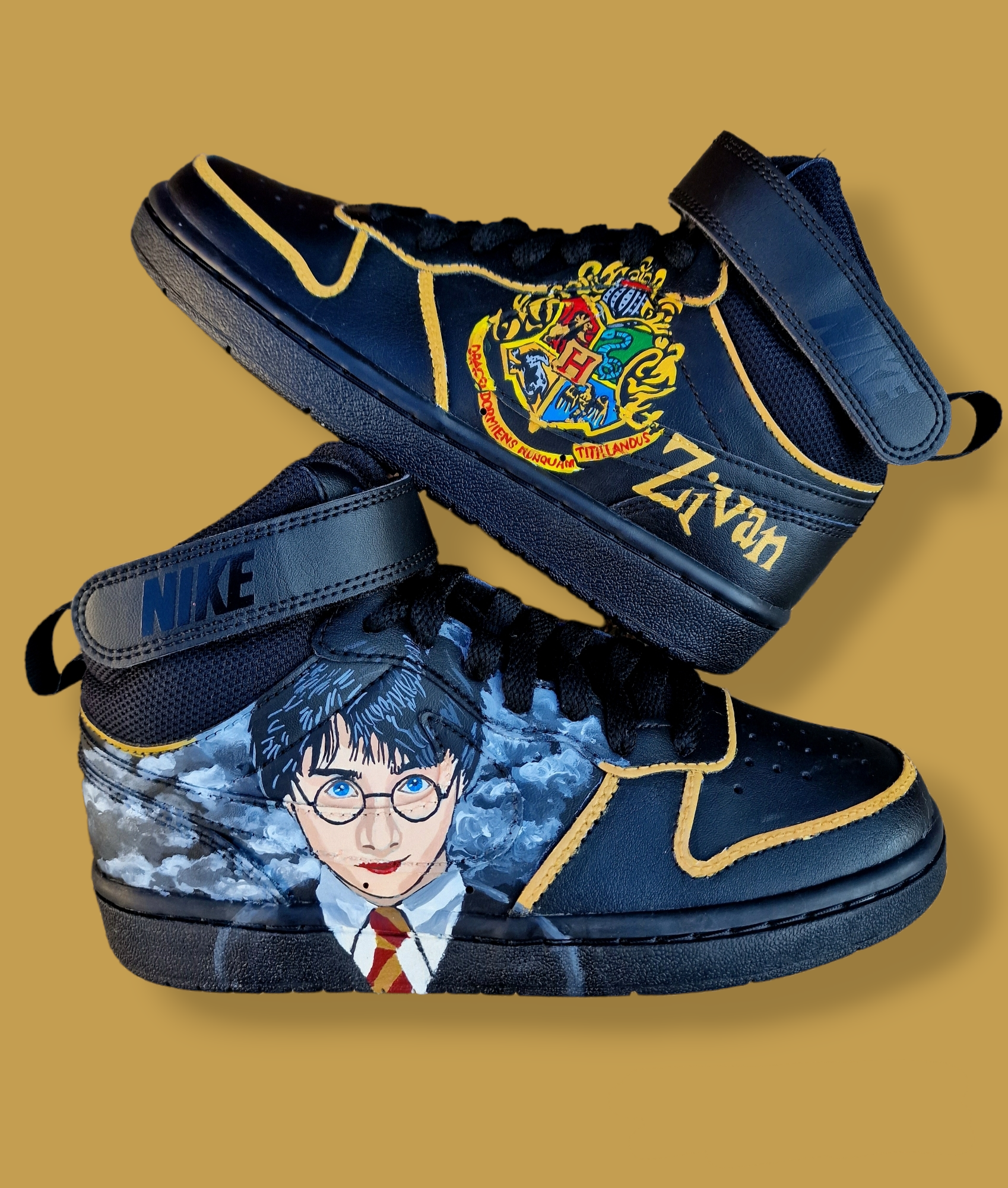 A pair of black Nike AF1 kids sneakers custom hand-painted with a vivid Harry Potter portrait on one side and the colorful Hogwarts Crest on the other, accented with a personalized name in golden lettering. The shoes feature fine detail brushwork, durable waterproof finish, and premium craftsmanship perfect for young Harry Potter fans looking for a magical, unique pair of custom kicks.
