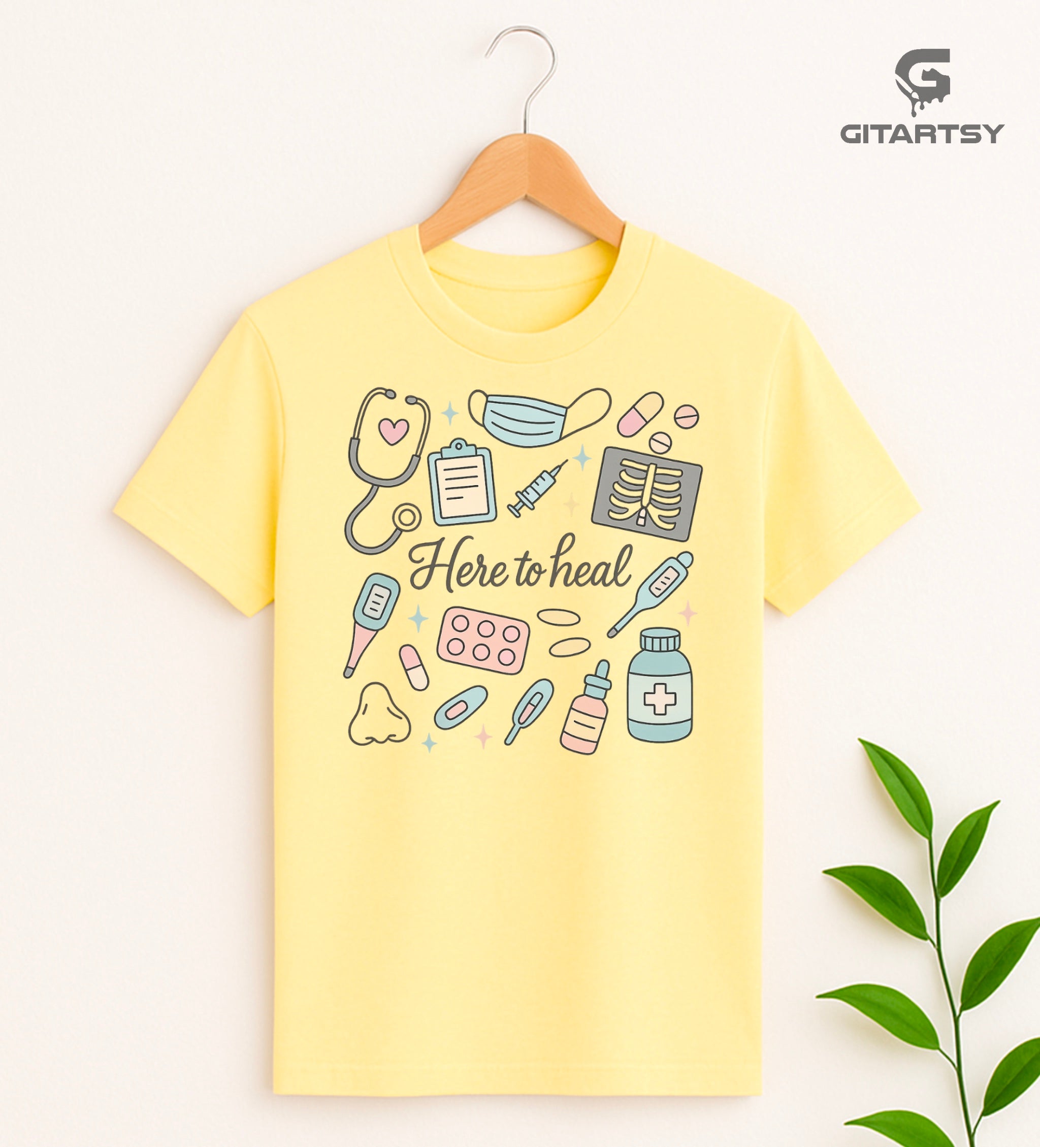 T-shirt with pastel medical illustrations and the phrase “Here to Heal” – ideal for doctors, nurses, and healthcare professionals - yellow