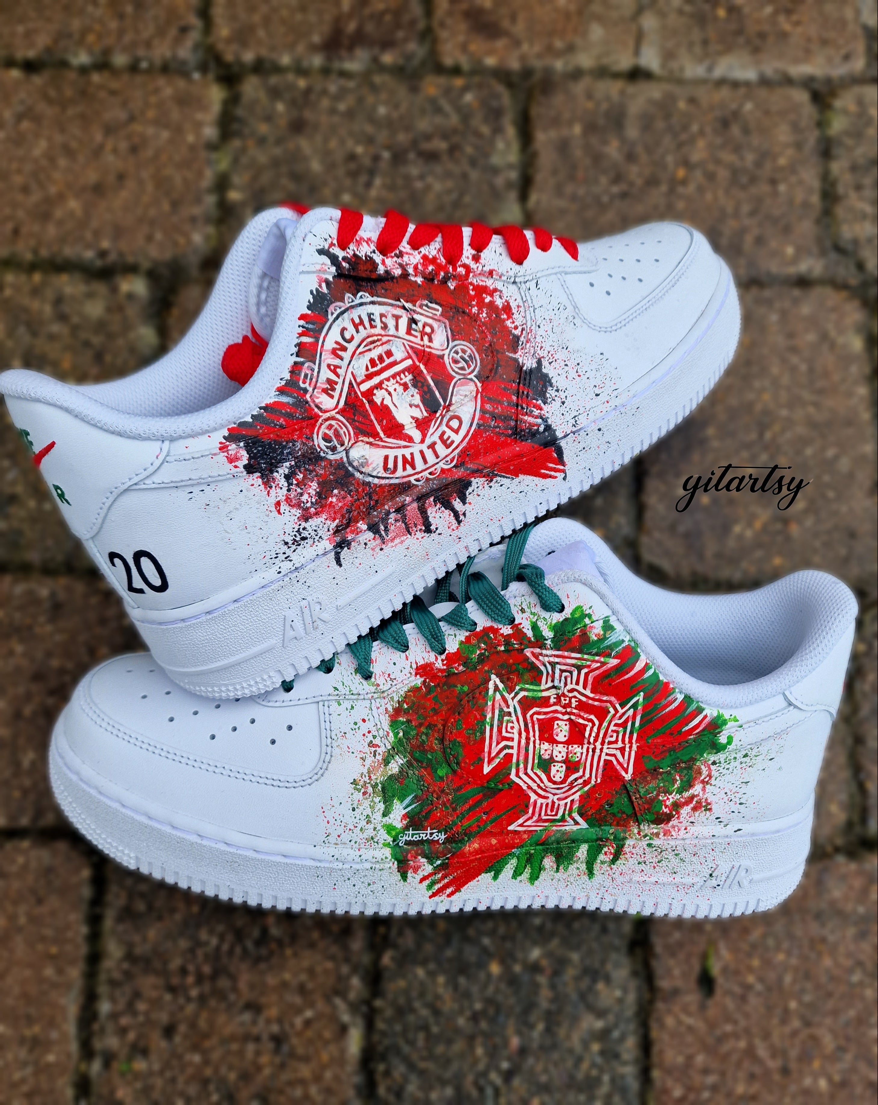 "Custom hand-painted Nike Air Force 1 sneakers featuring Manchester United and Portugal national football team crests, splattered in bold red, green, and black paint with unique details, crafted by Gitartsy."