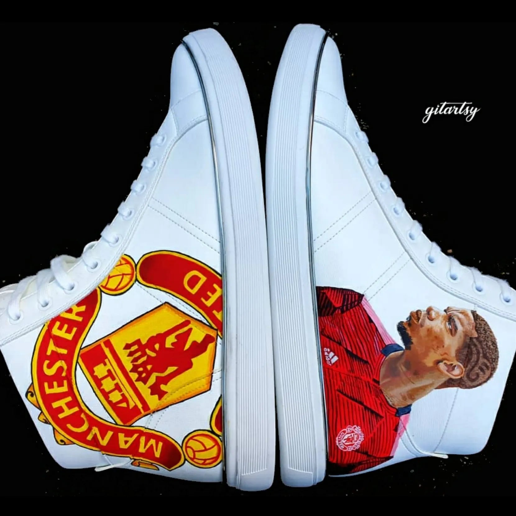 A realistic portrait of Paul Pogba and Manchester United logo hand painted on high-top white sneakers