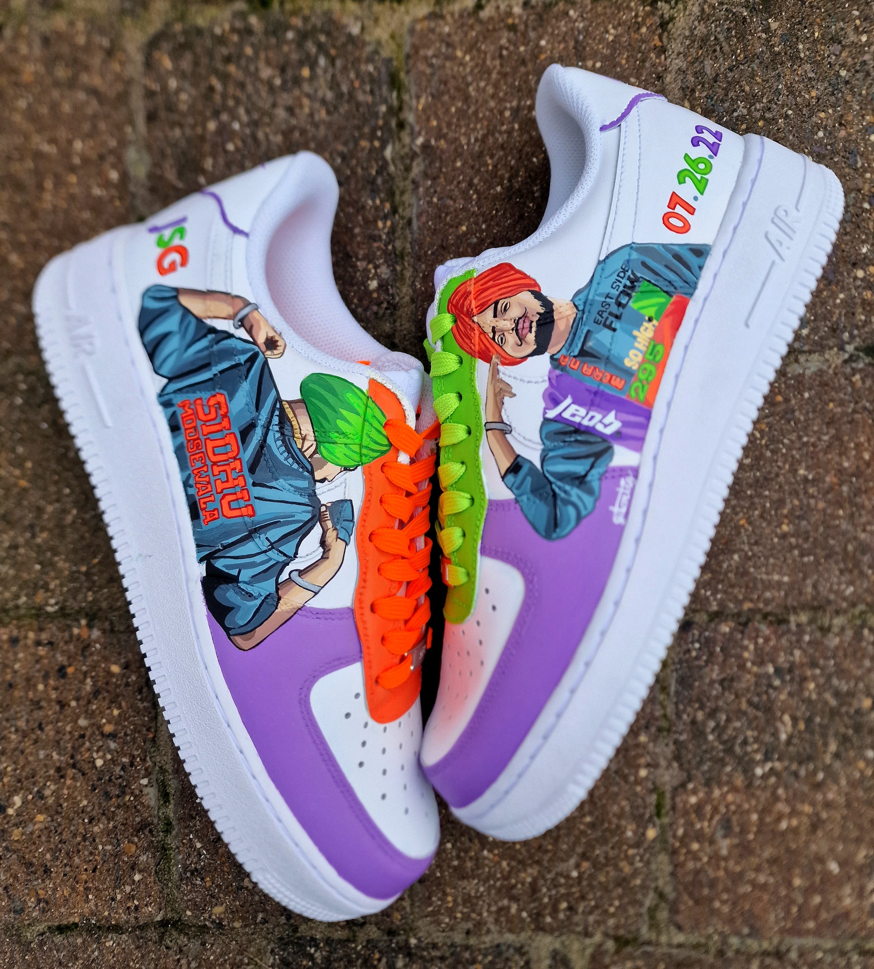 Custom white Nike Air Force 1 sneakers featuring hand-painted, realistic portraits of Sidhu Moosewala. Includes neon colors like bright green, orange, and purple, with lyrical references to his hit songs “295”, “So High”, and “East Side Flow”. Painted by Gitartsy, this wearable art also includes his name, tribute date “07.26.22”, and signature bold streetwear vibes.