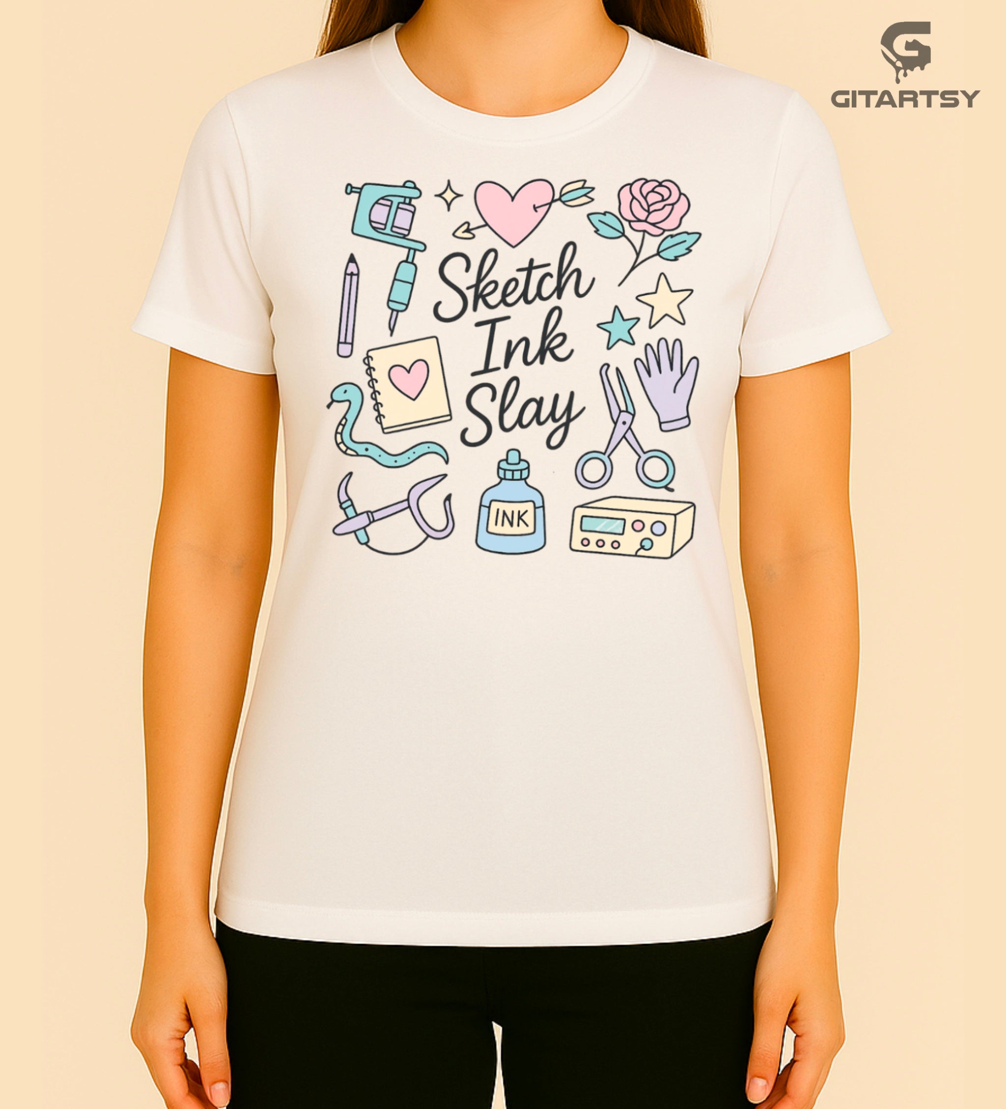 T-shirt for tattoo artists featuring pastel illustrations of tattoo machines, ink, sketchpad, and "Sketch Ink Slay" text