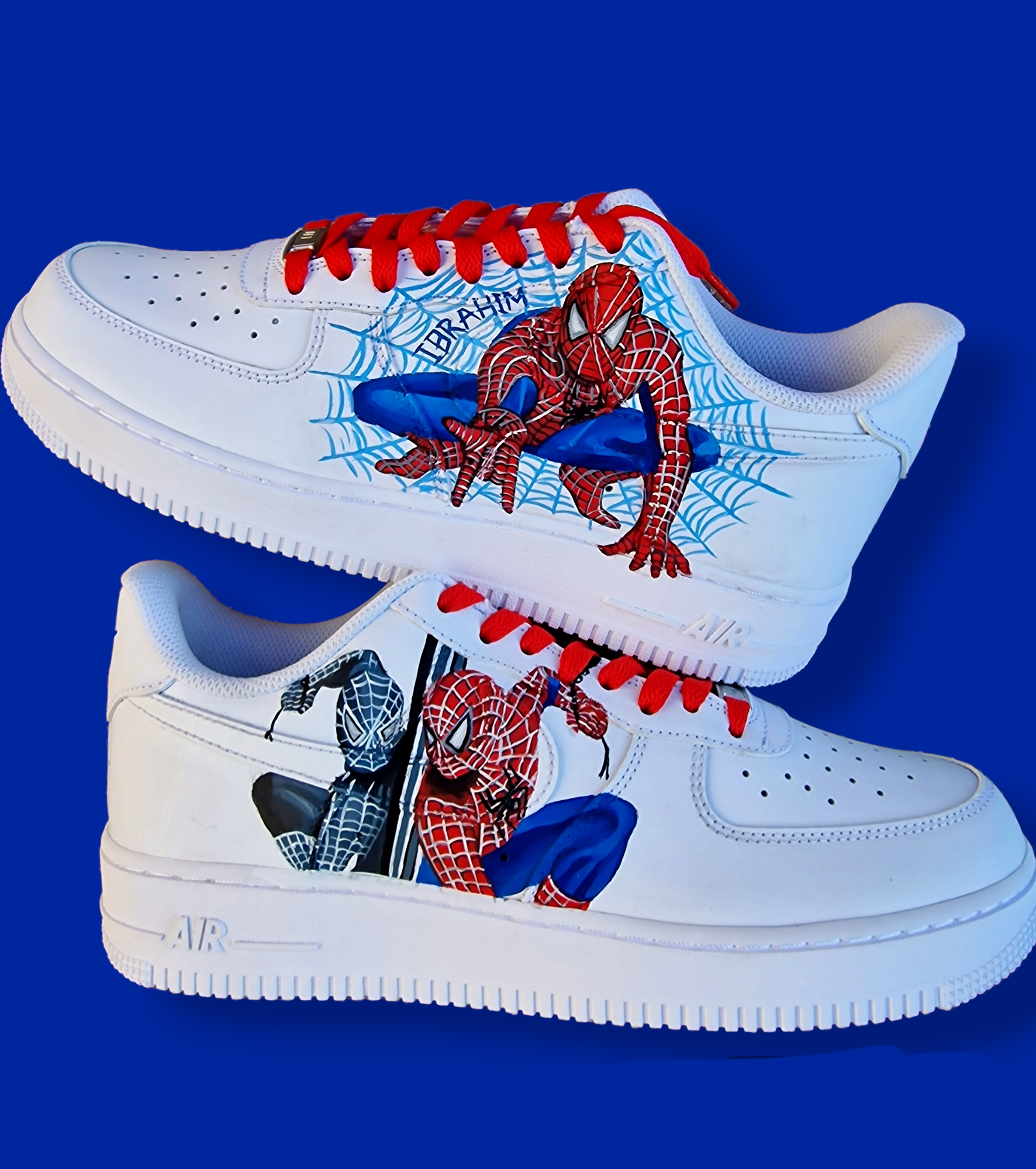 Hand-painted custom Spiderman Nike AF1 kids sneakers with red and black Spiderman portraits, detailed web design, and personalized name on white leather shoes.