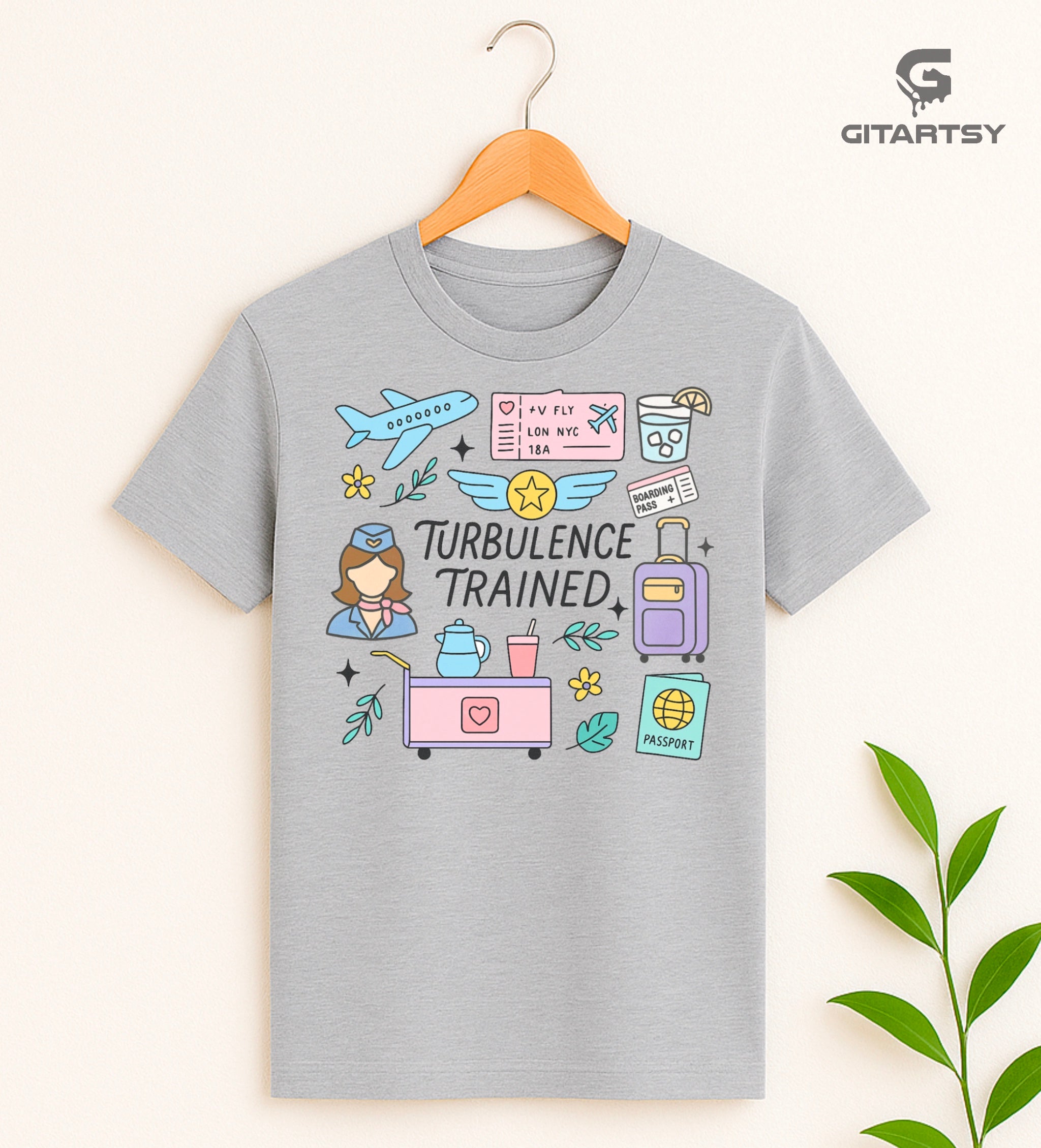 T-shirt featuring the quote "Turbulence Trained" with pastel illustrations of airplane, boarding pass, drinks cart, and flight attendant – ideal for cabin crew and aviation professionals.