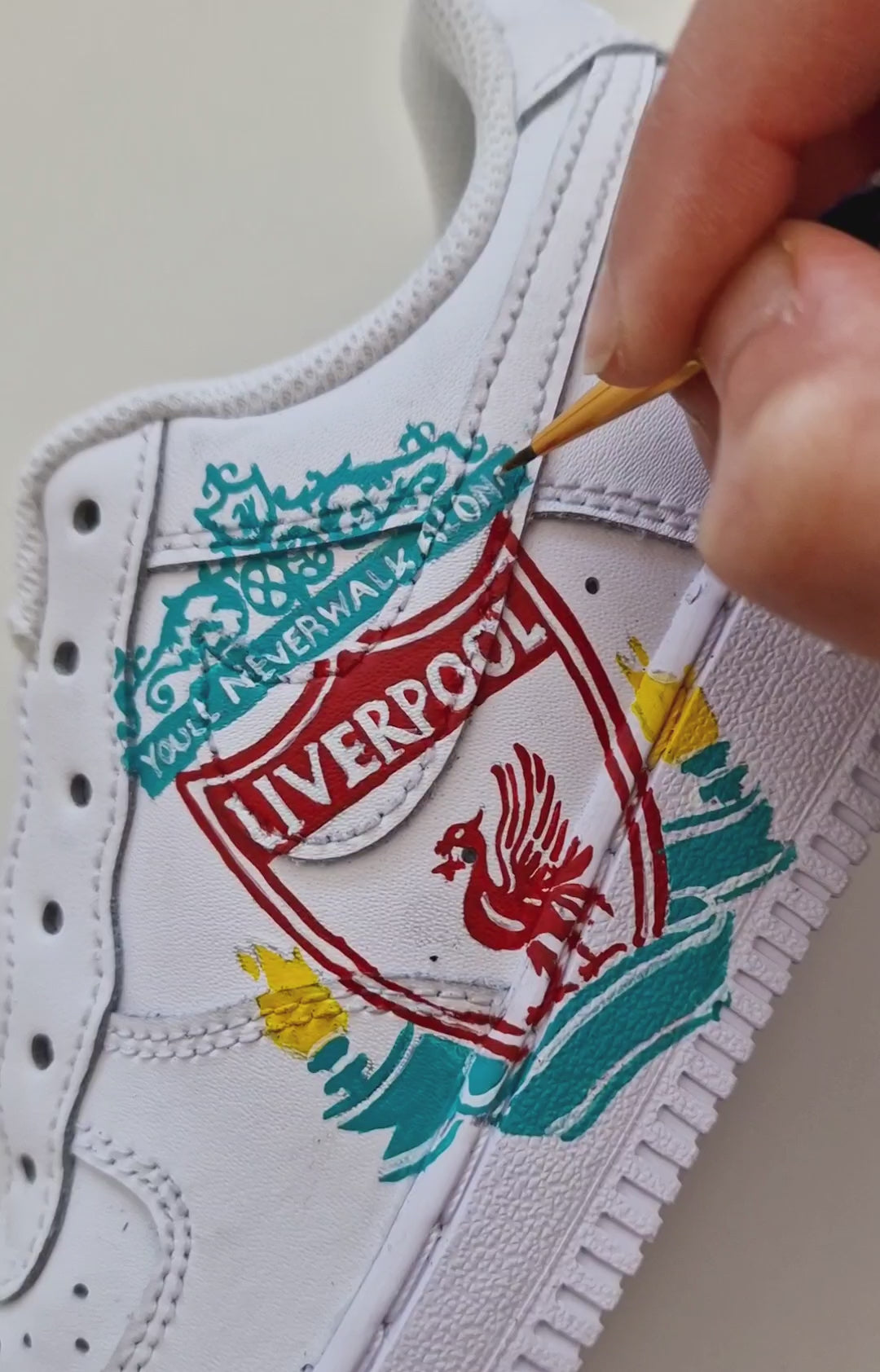 Custom Nike sneakers for kids showcasing Liverpool FC Liverbird art