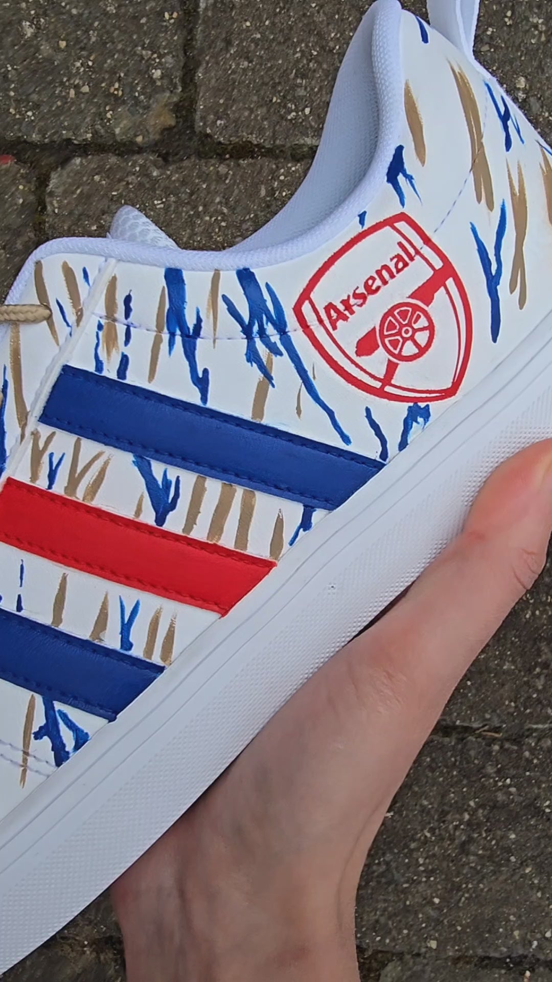 Arsenal FC Football Custom Hand-Painted Adidas Sneakers - white base shoes with  red blue and gold artwork inspired by Arsenal football club. Painted with bold brushstrokes