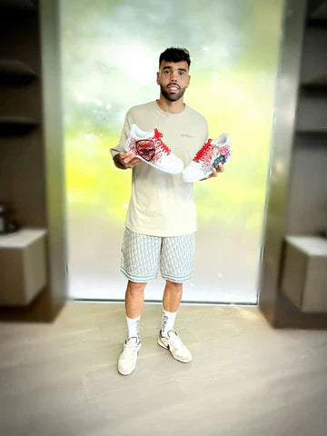 David Raya footballer holding custom sneakers by gitartsy - nike af1 with team logos
