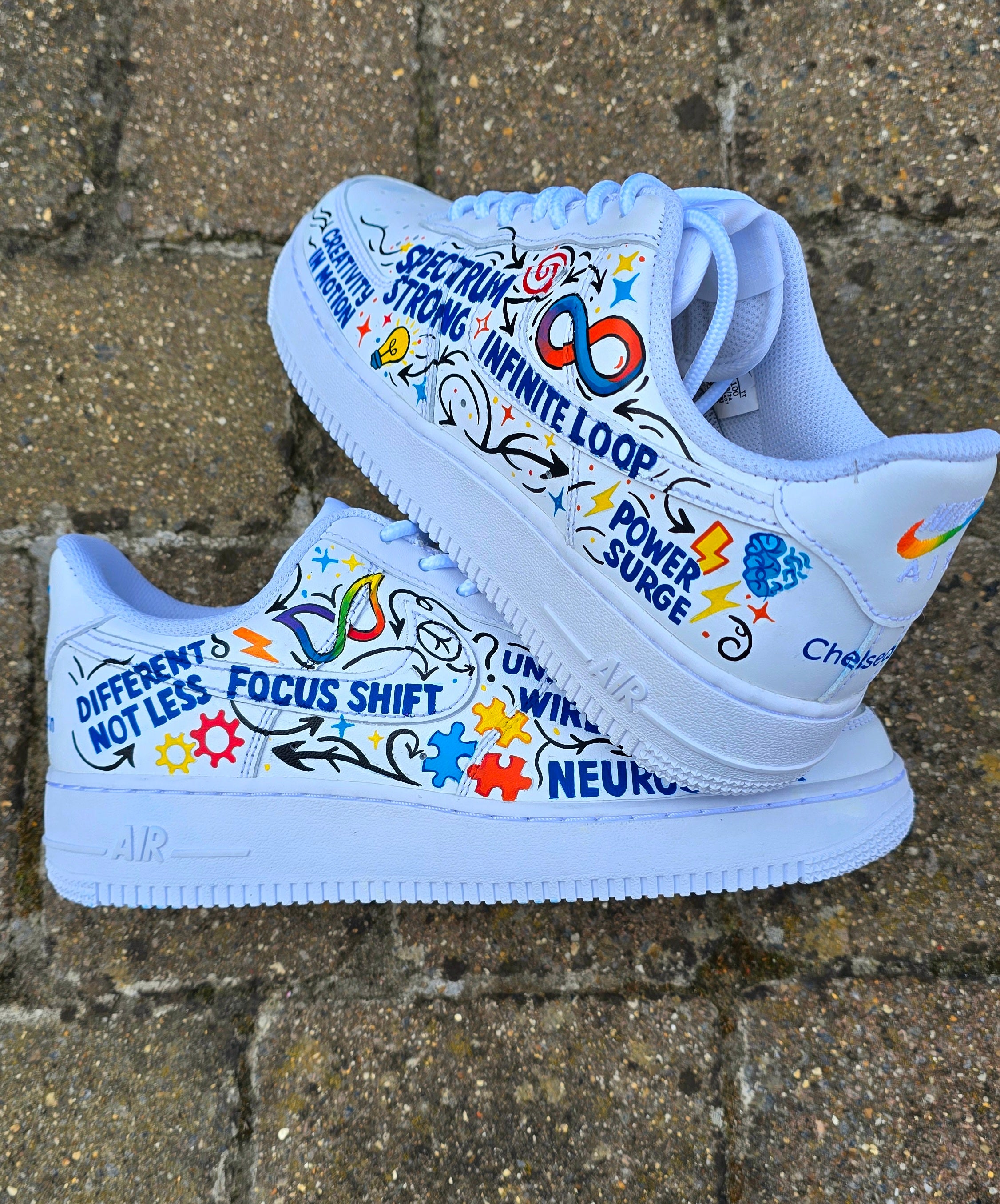 Custom hand-painted Nike Air Force 1 sneakers featuring a vibrant ADHD and Autism awareness design. Includes colourful puzzle pieces, infinity symbols, inspirational typography, and Chelsea FC Foundation branding. Crafted using waterproof and UV-protected leather paints for long-lasting wear. Each pair is unique, representing creativity, inclusivity, and neurodiversity. Perfect for collectors, awareness events, and personal expression.

