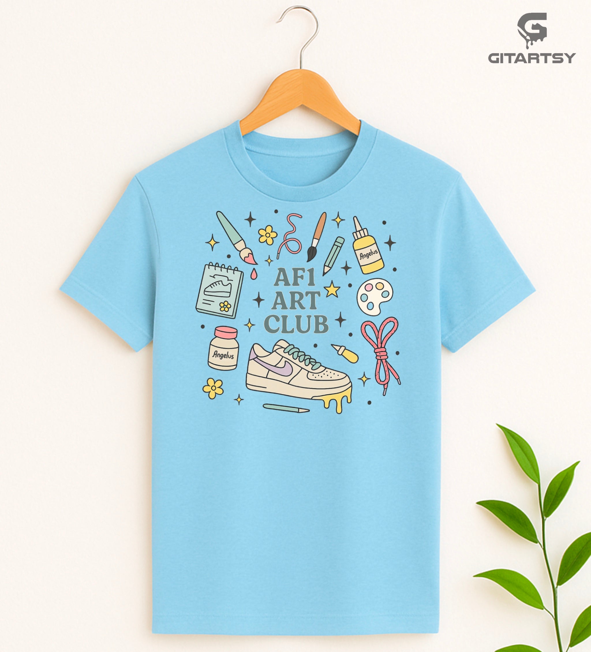 Pastel “AF1 Art Club” T-shirt featuring custom sneaker tools, Angelus paint bottles, laces, and AF1 art illustrations – perfect for shoe customisers and sneaker artists.