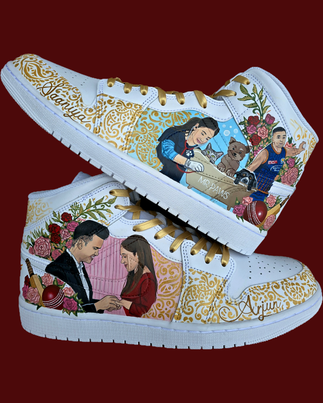 A pair of nike jordan 1 white high-top sneakers with custom illustrations of a couple Arjun Tendulkar and Saaniya Chandhok with gold paisley patterns henna, pets, florals with maroon and blue colour scheme displayed against a dark red background with a GITARTSY logo in the corner.