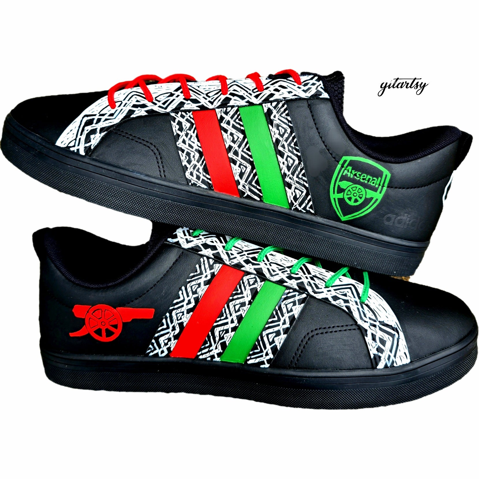 Hand painted custom Arsenal 24/25 Away Kit inspired Black Adidas shoes sneakers trainers. Painted with bold white African designs and colours - green, red and white on black. Arsenal fc logo painted in green