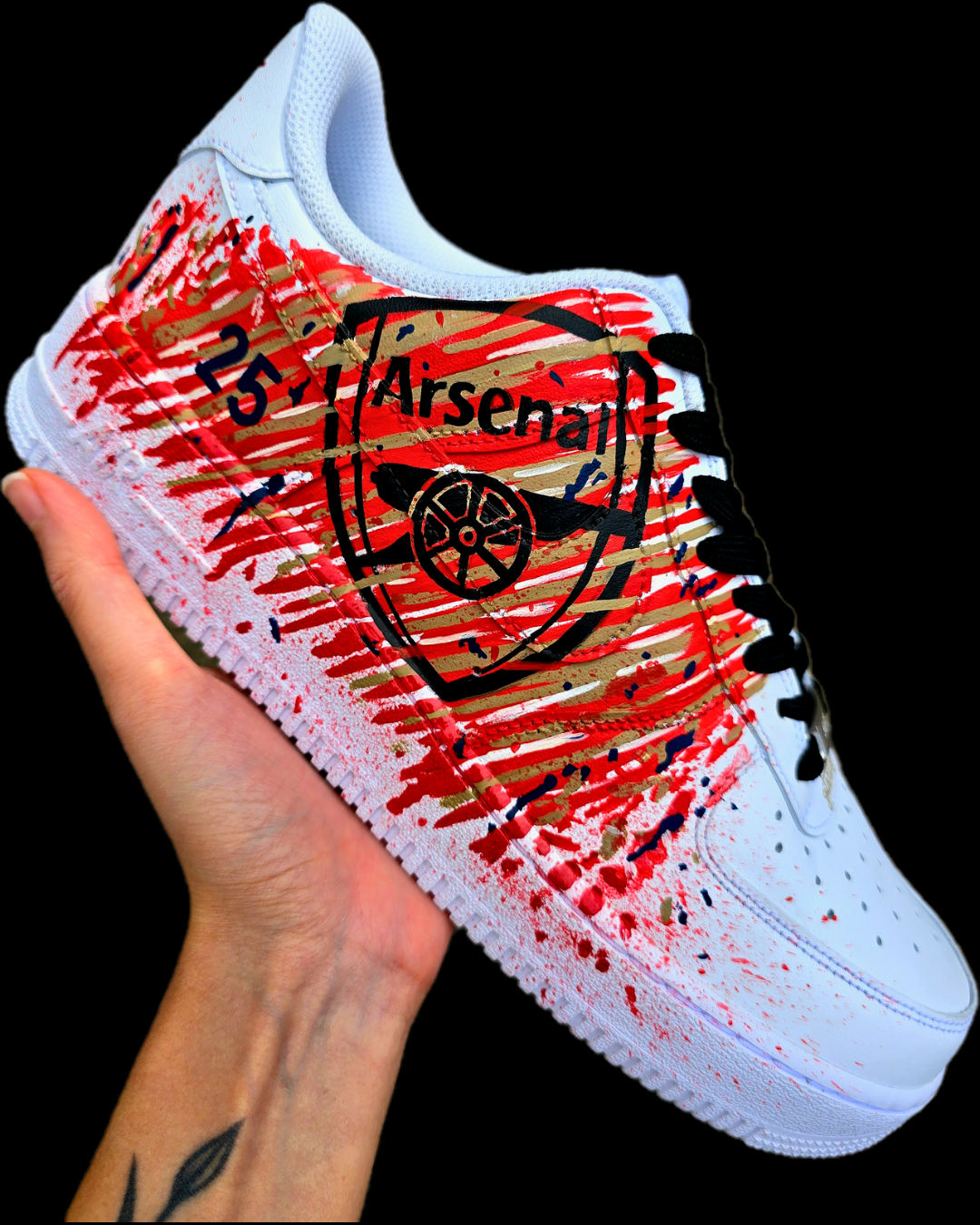 Custom hand-painted Nike Air Force 1 sneakers with Arsenal FC-inspired design, featuring red, gold, and navy brush strokes, personalized details like player name and number, Arsenal logo, and splatter effect art—crafted on a genuine white leather Nike AF1 base by Gitartsy.


