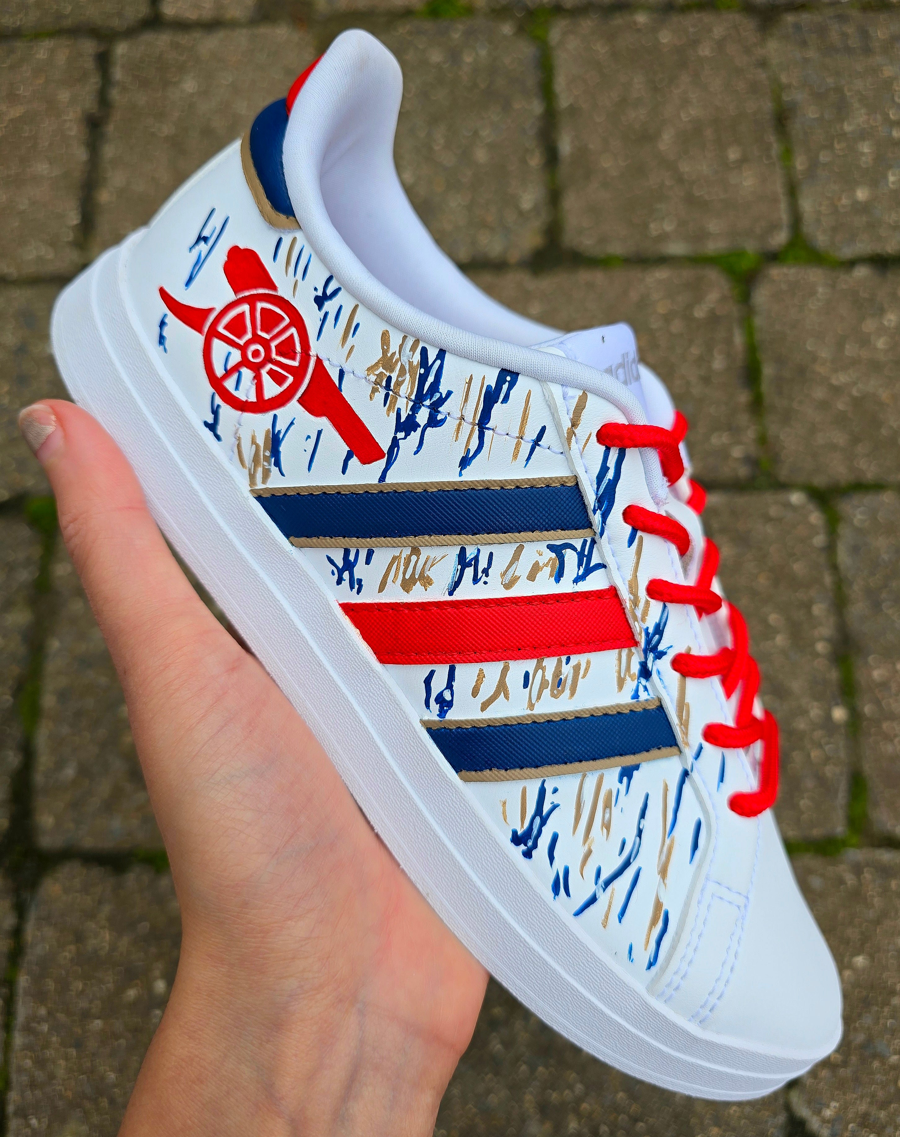 Arsenal FC Football Custom Hand-Painted Adidas Sneakers - Hand Painted with red, gold and blue artistic brushstrokes. Realistic arsenal fc logo and gunners logo