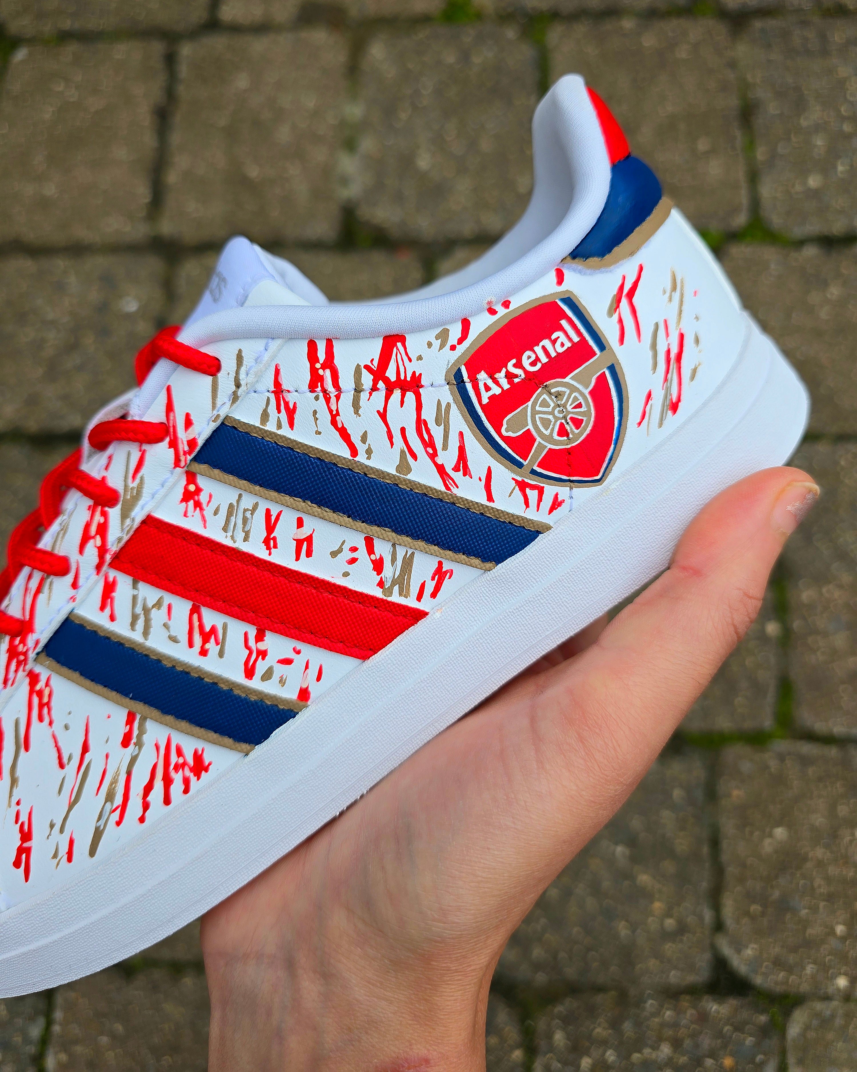 Arsenal FC Football Custom Hand-Painted Adidas Sneakers - Hand Painted with red, gold and blue artistic brushstrokes. Realistic arsenal fc logo and gunners logo