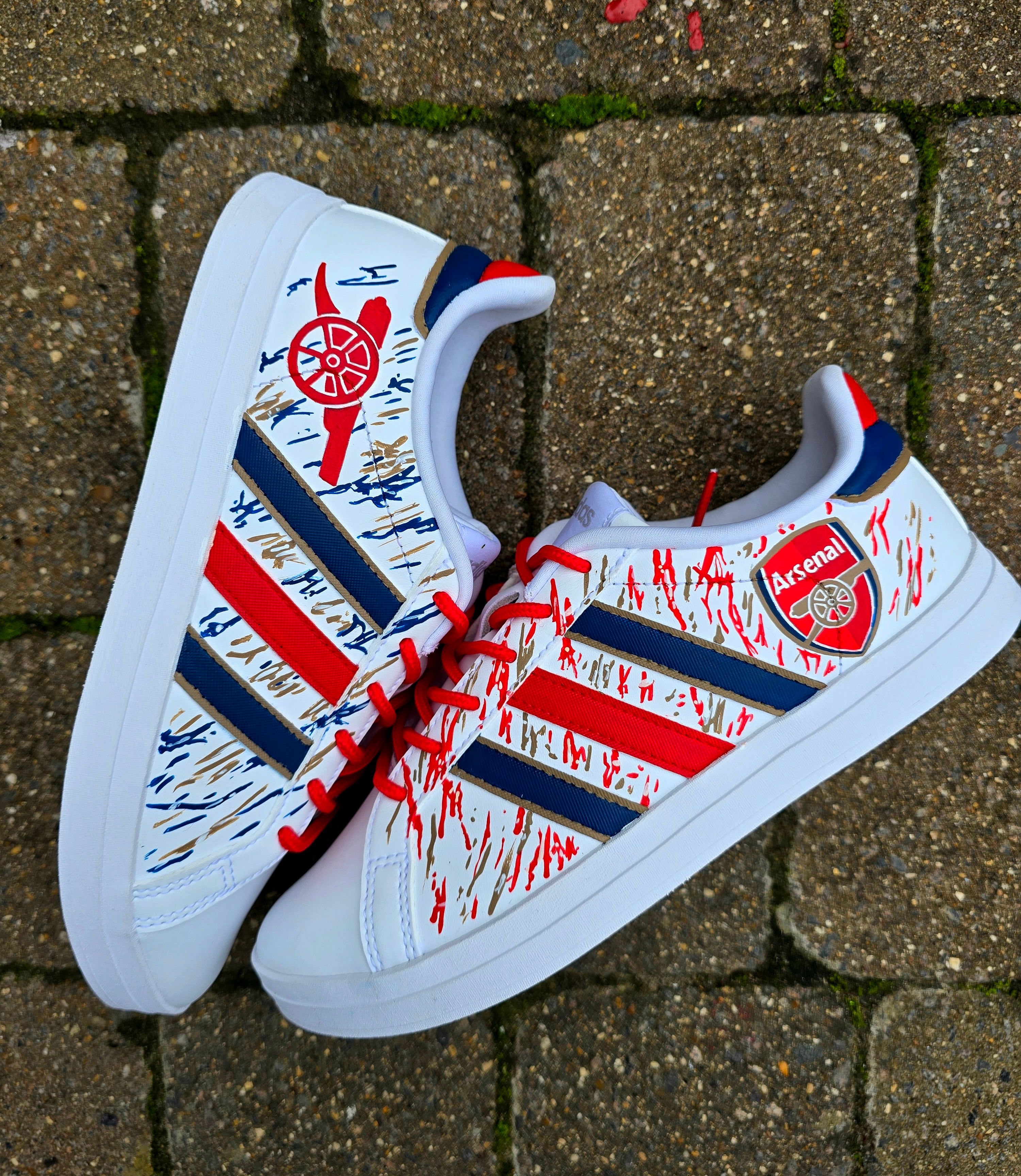 Arsenal FC Football Custom Hand-Painted Adidas Sneakers - Hand Painted with red, gold and blue artistic brushstrokes. Realistic arsenal fc logo and gunners logo