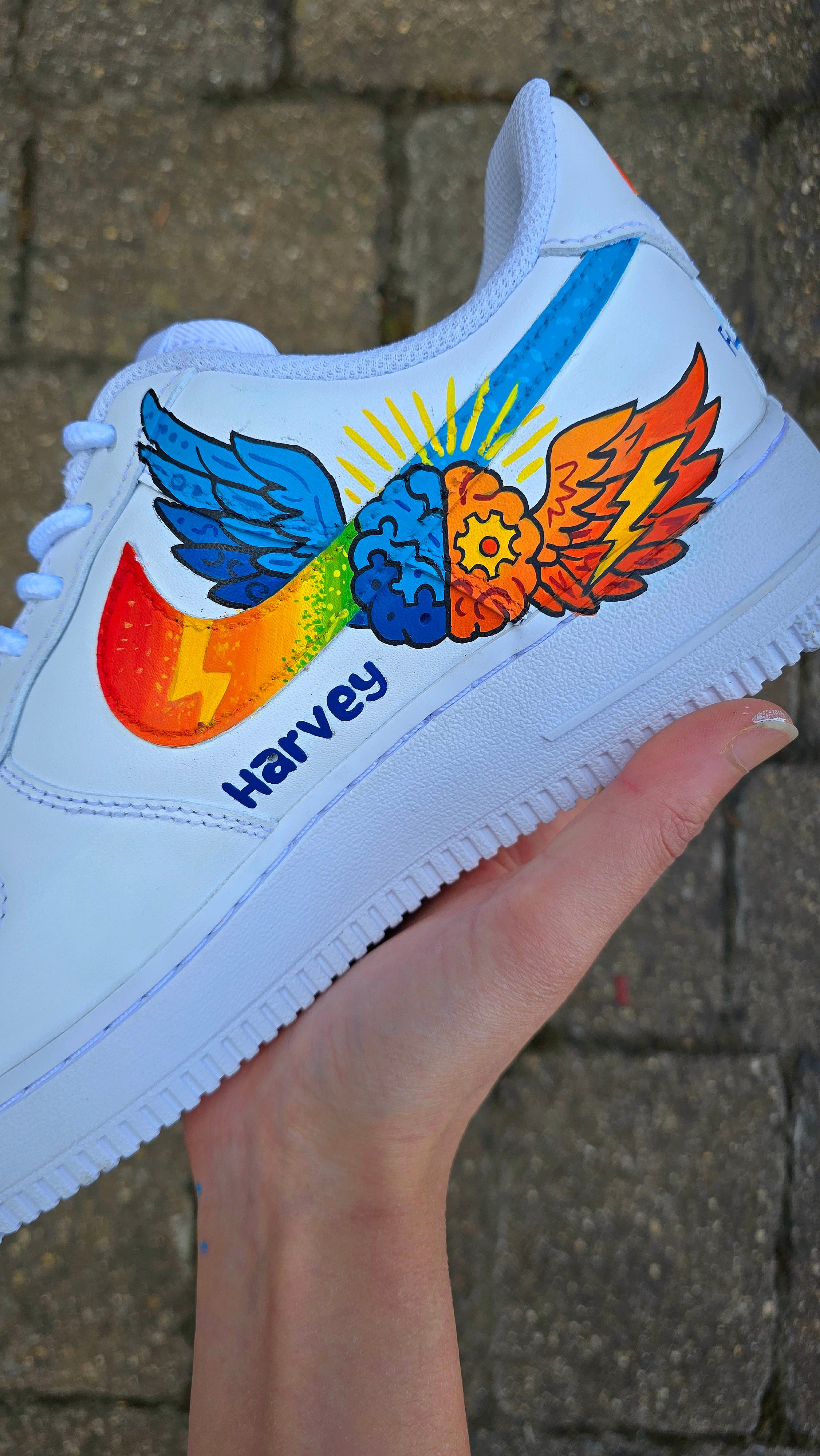 Custom hand-painted Nike Air Force 1 sneakers featuring a vibrant ADHD and Autism awareness design. Includes colourful puzzle pieces, infinity symbols, inspirational typography, and Chelsea FC Foundation branding. Crafted using waterproof and UV-protected leather paints for long-lasting wear. Each pair is unique, representing creativity, inclusivity, and neurodiversity. Perfect for collectors, awareness events, and personal expression.

