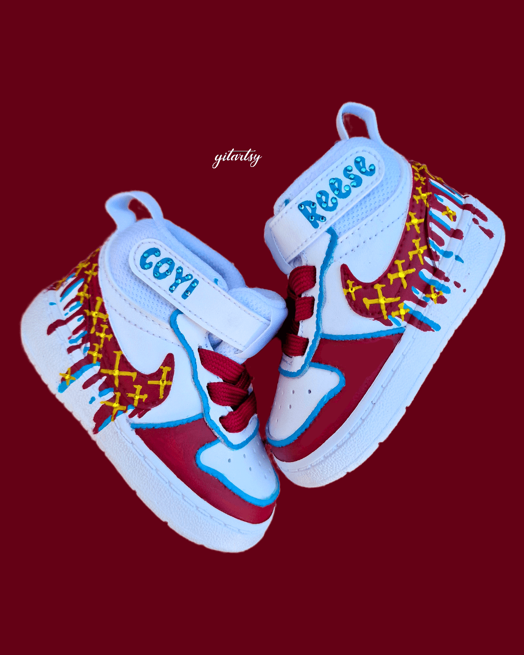 Custom hand-painted baby sneakers inspired by West Ham United, featuring claret and blue color detailing, dripping paint effect, crossed hammers, and personalised names or messages on the straps. Perfect for infant football fans and thoughtful baby gifts.

