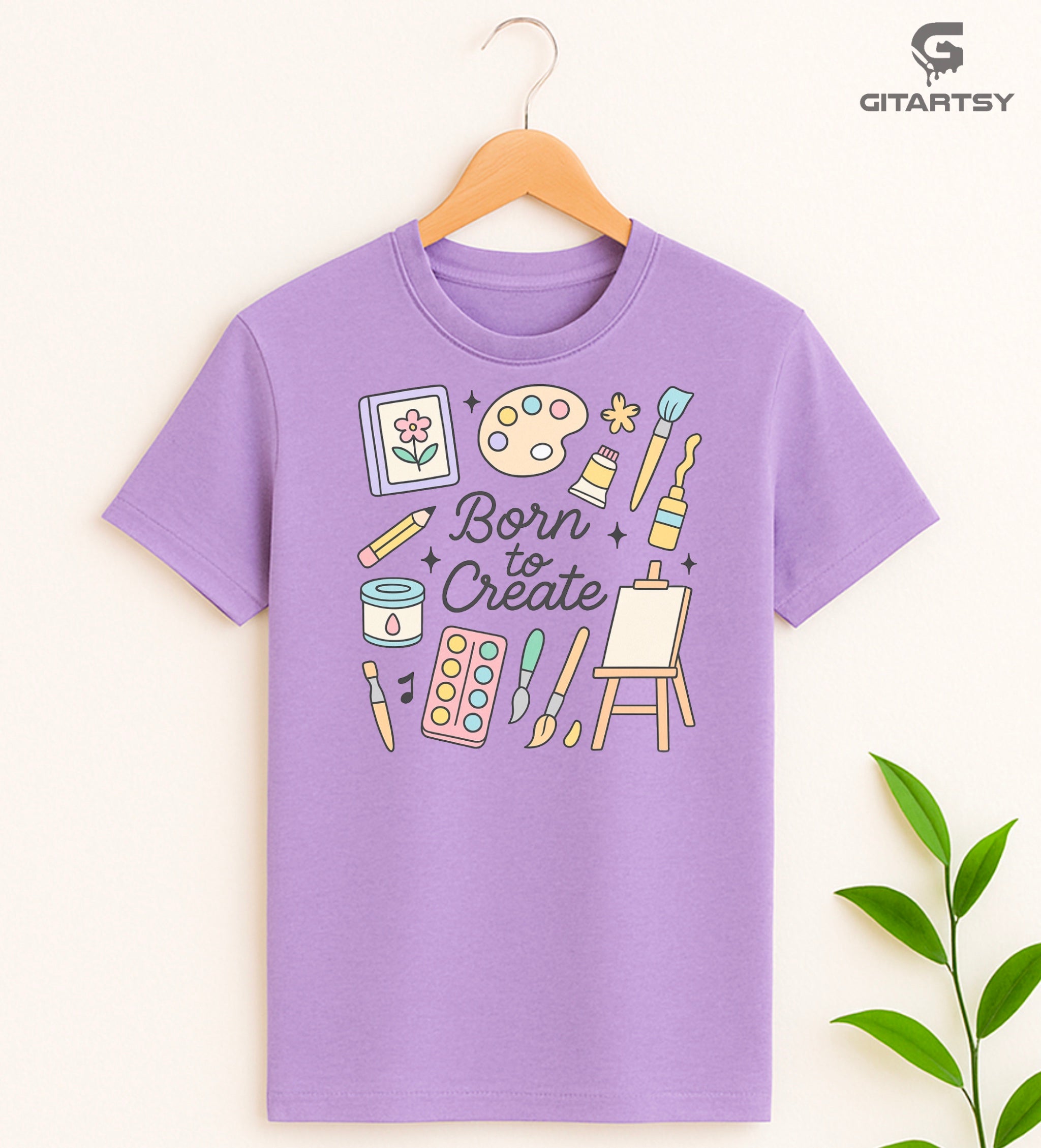 "Born to Create" pastel art T-shirt for fine artists with doodles of brushes, easel, paint tubes, and creative tools on a cotton tee