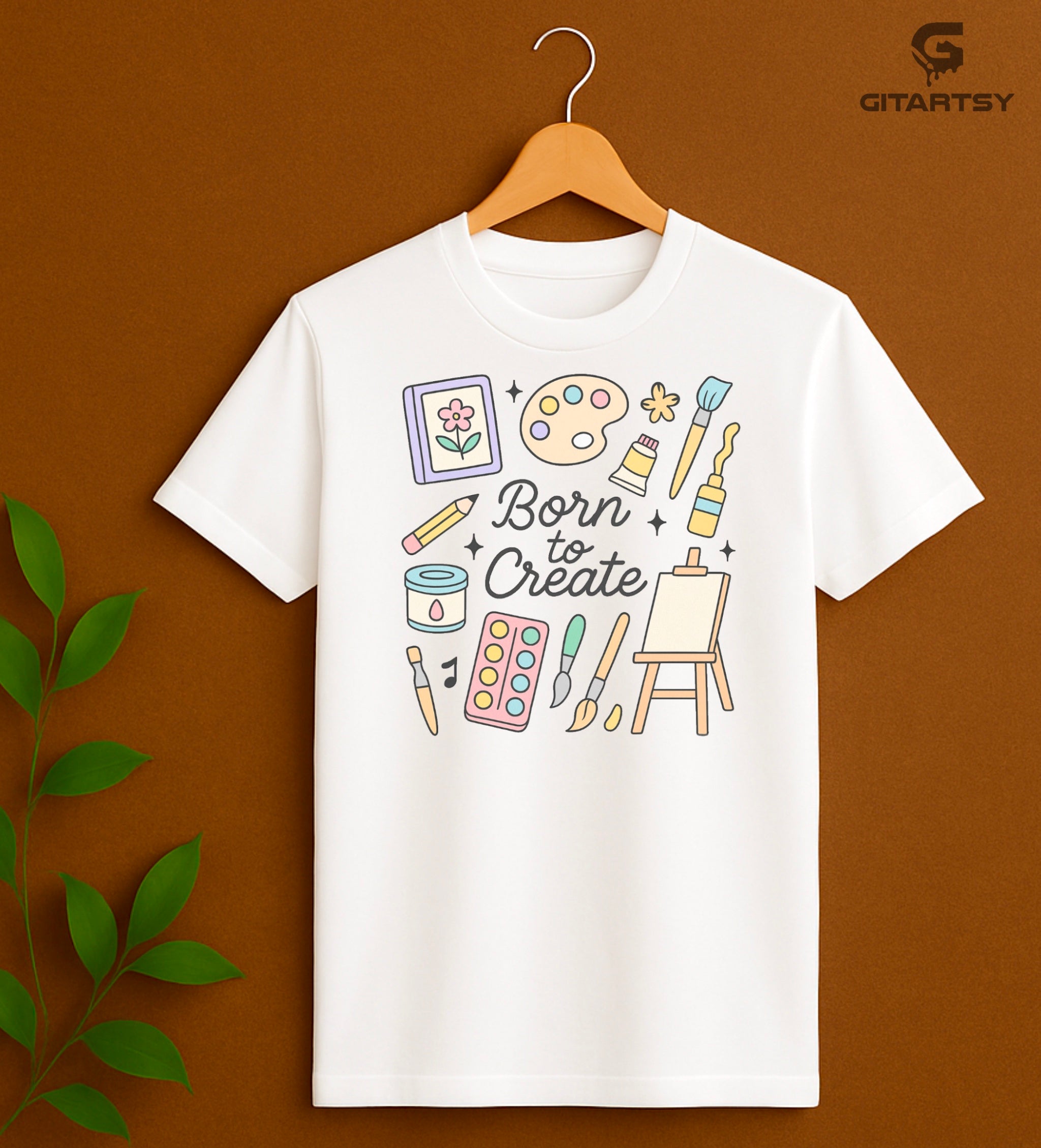 "Born to Create" pastel art T-shirt for fine artists with doodles of brushes, easel, paint tubes, and creative tools on a cotton tee