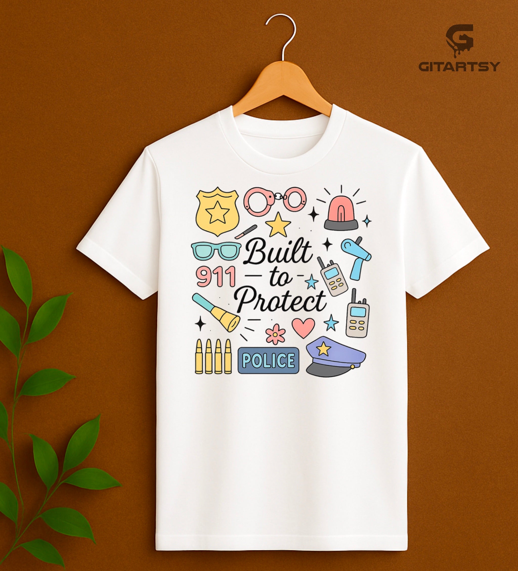 Pastel graphic T-shirt for policewomen with icons like badges, handcuffs, sirens, and 911 – “Built to Protect” slogan in stylish typography.