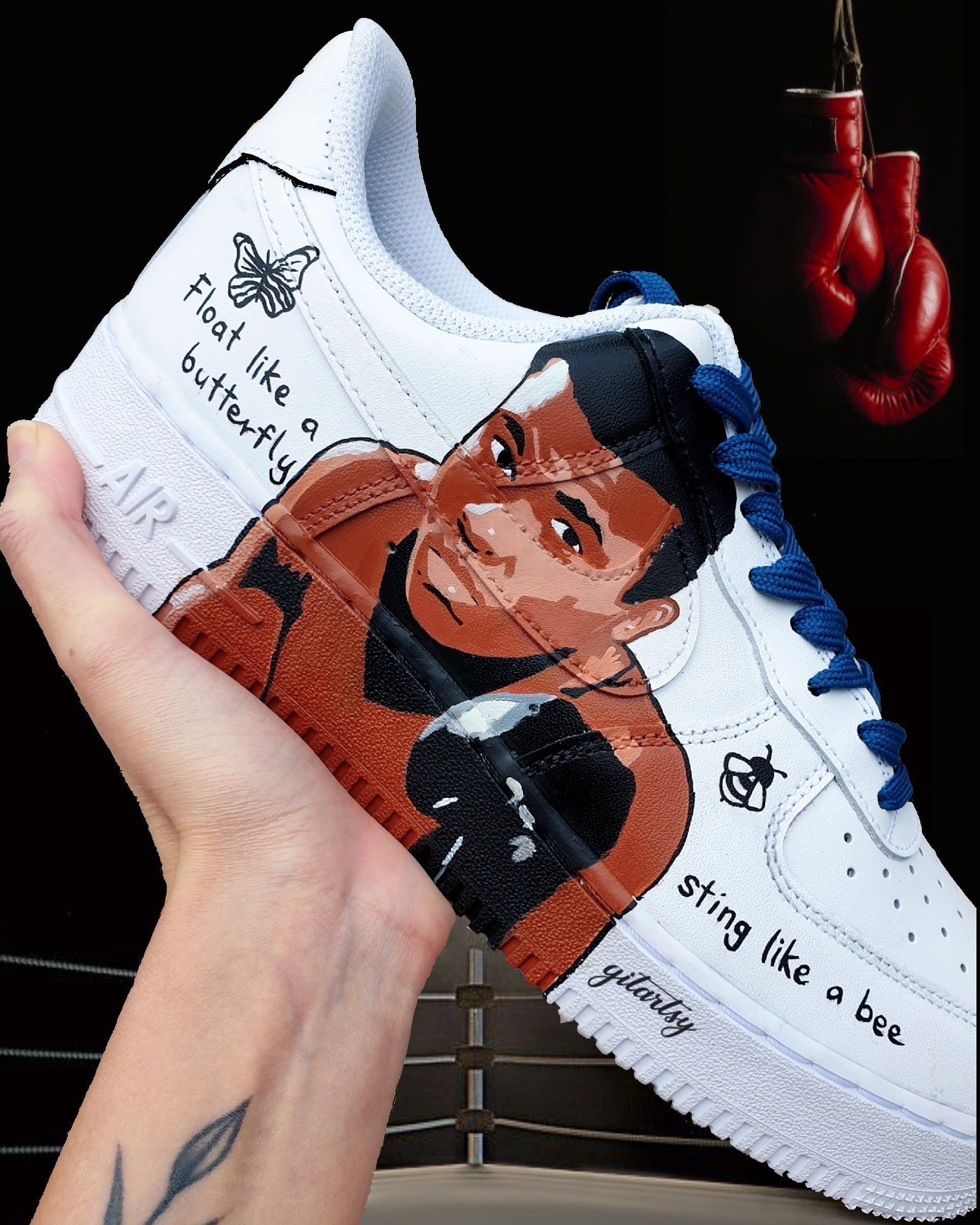 "Hand-painted Nike Air Force 1 sneakers featuring detailed portraits of boxing legends Muhammad Ali and Vasiliy Lomachenko, custom artwork with boxing gloves, quotes, and championship symbols, by Gitartsy."

