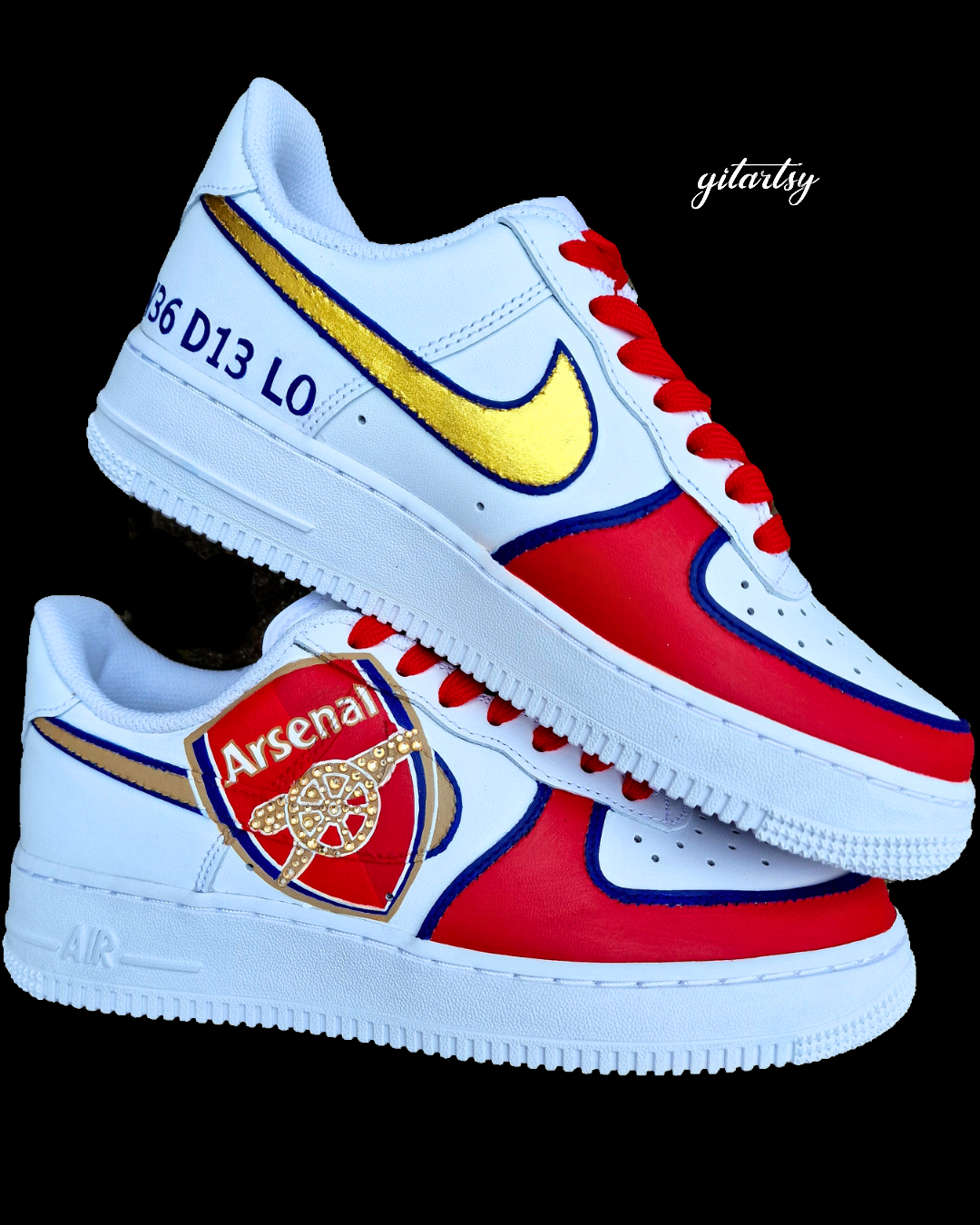 Custom Arsenal-themed Nike Air Force 1 sneakers featuring a bold red and white color scheme with royal blue accents. The shoes showcase a large 3D Arsenal FC crest on the outer panel of each shoe, highlighted with gold crystals embedded into the iconic cannon. A shimmering gold Nike swoosh with blue outline complements the hand-painted design. Red laces, team postcodes, and jersey numbers complete the sporty, fan-focused look. Perfect for football supporters or sneaker collectors. Authentically hand-painted