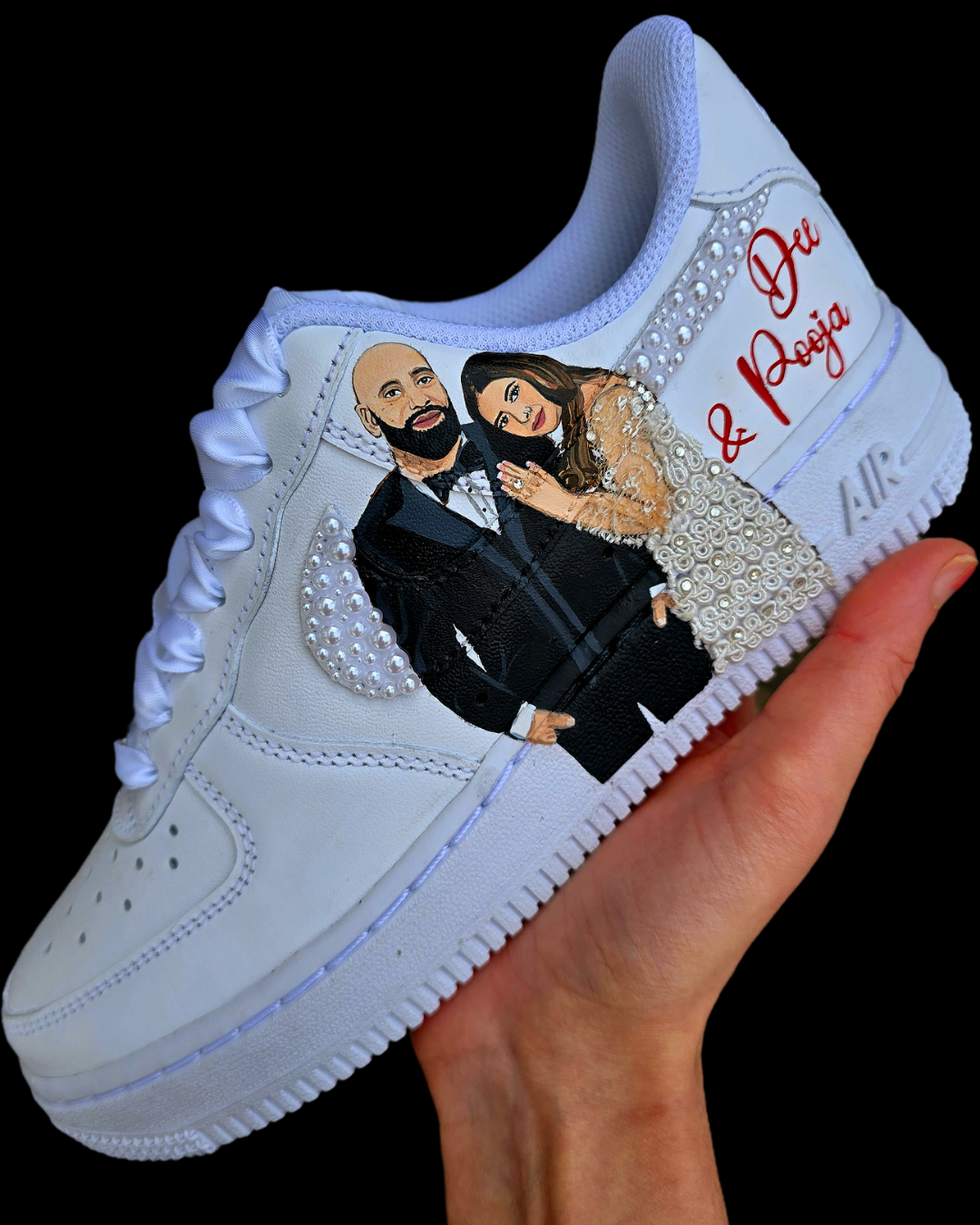 Custom Nike Air Force 1 sneakers hand-painted with a realistic bride and groom portrait, wedding attire details, and personalised touches such as names and dates. Embellished with pearls, rhinestones, and gold accents, these sneakers feature intricate artwork depicting the couple in formal wear and symbolic wedding imagery like clasped hands. Crafted with professional-grade leather paints and sealed for long-lasting wear, these wedding edition shoes combine comfort, style, and sentimental value.

