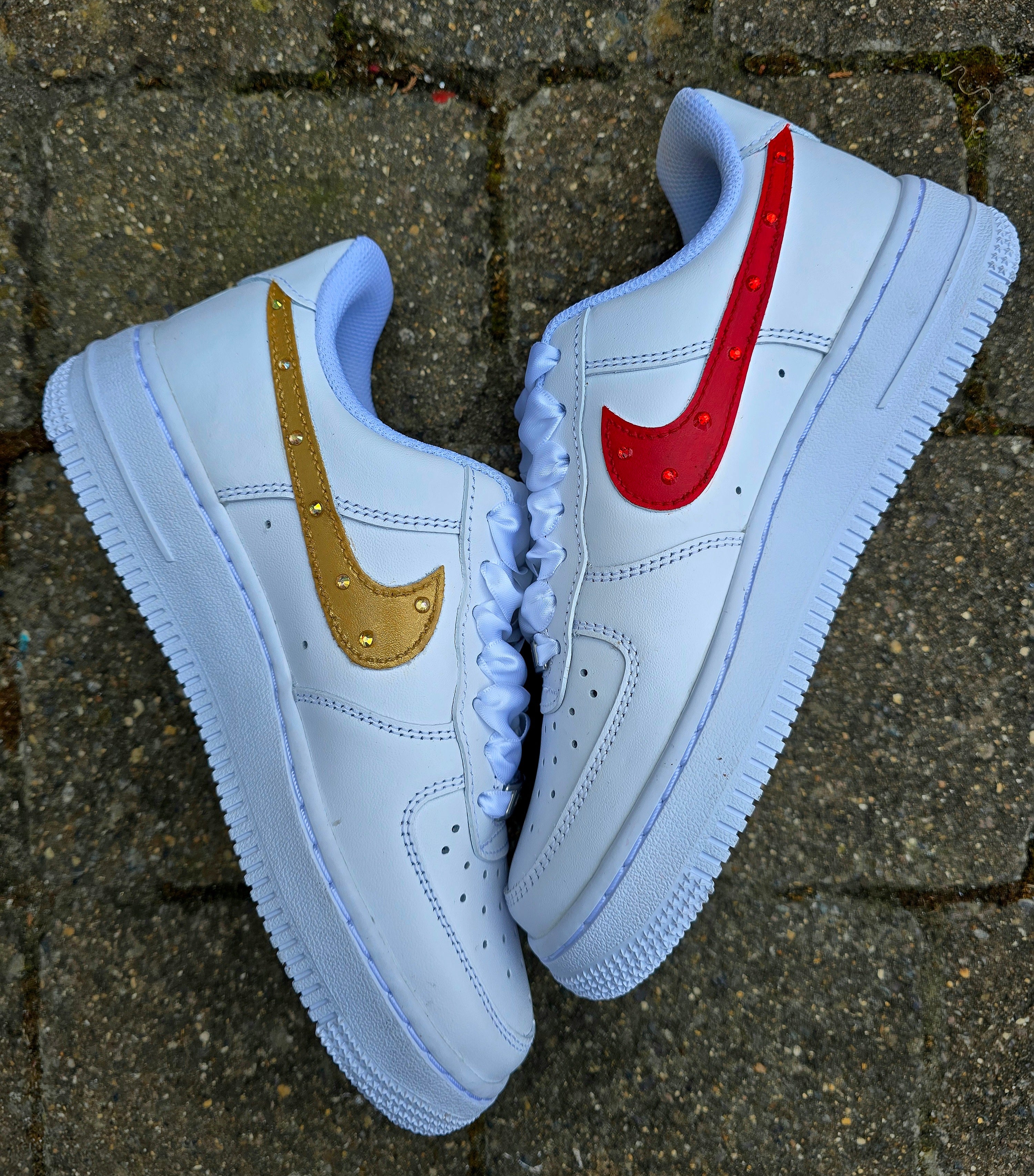Custom Nike Air Force 1 sneakers hand-painted with a realistic bride and groom portrait, wedding attire details, and personalised touches such as names and dates. Embellished with pearls, rhinestones, and gold accents, these sneakers feature intricate artwork depicting the couple in formal wear and symbolic wedding imagery like clasped hands. Crafted with professional-grade leather paints and sealed for long-lasting wear, these wedding edition shoes combine comfort, style, and sentimental value.

