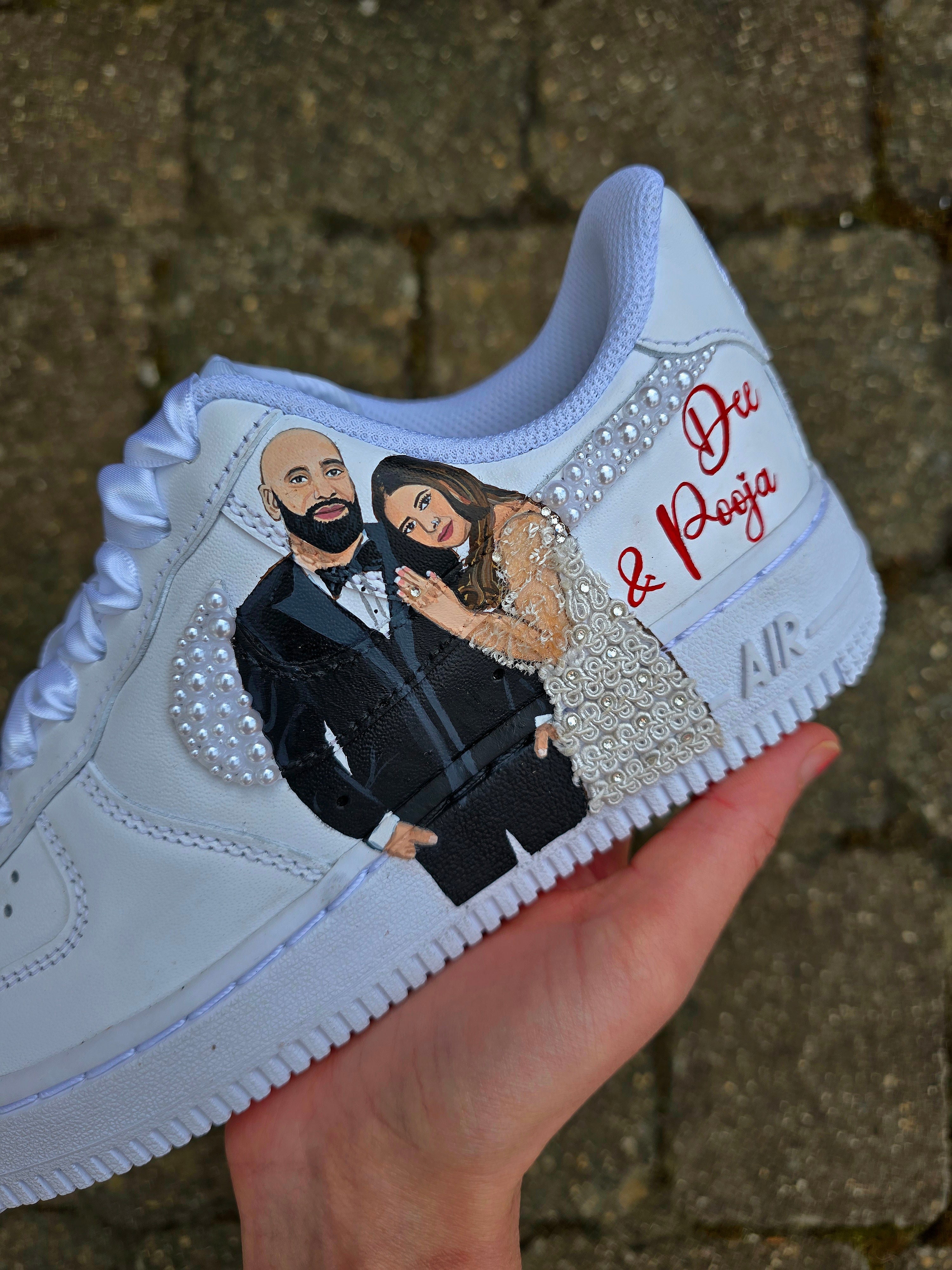 Custom Nike Air Force 1 sneakers hand-painted with a realistic bride and groom portrait, wedding attire details, and personalised touches such as names and dates. Embellished with pearls, rhinestones, and gold accents, these sneakers feature intricate artwork depicting the couple in formal wear and symbolic wedding imagery like clasped hands. Crafted with professional-grade leather paints and sealed for long-lasting wear, these wedding edition shoes combine comfort, style, and sentimental value.

