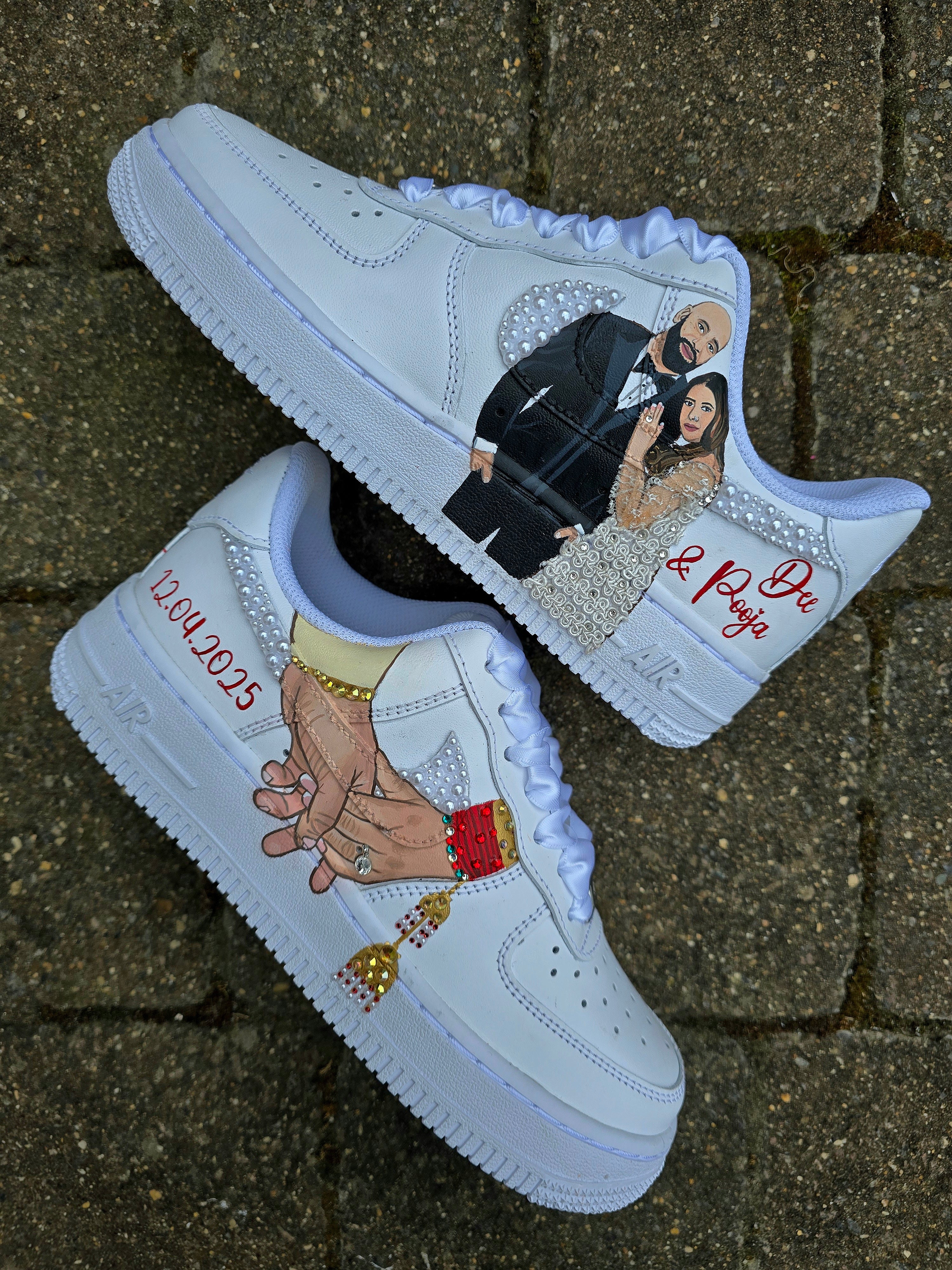Custom Nike Air Force 1 sneakers hand-painted with a realistic bride and groom portrait, wedding attire details, and personalised touches such as names and dates. Embellished with pearls, rhinestones, and gold accents, these sneakers feature intricate artwork depicting the couple in formal wear and symbolic wedding imagery like clasped hands. Crafted with professional-grade leather paints and sealed for long-lasting wear, these wedding edition shoes combine comfort, style, and sentimental value.

