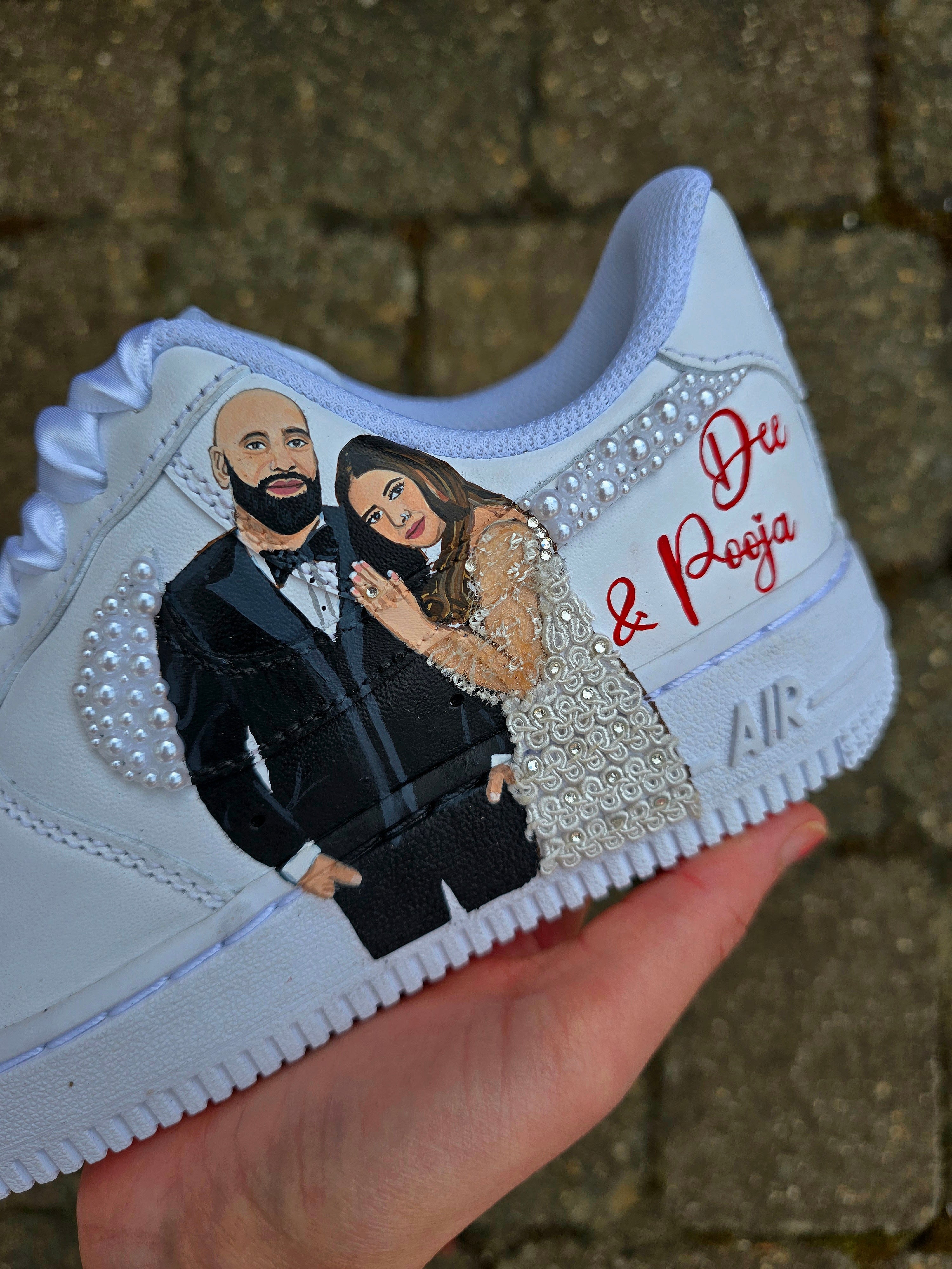 Custom Nike Air Force 1 sneakers hand-painted with a realistic bride and groom portrait, wedding attire details, and personalised touches such as names and dates. Embellished with pearls, rhinestones, and gold accents, these sneakers feature intricate artwork depicting the couple in formal wear and symbolic wedding imagery like clasped hands. Crafted with professional-grade leather paints and sealed for long-lasting wear, these wedding edition shoes combine comfort, style, and sentimental value.


