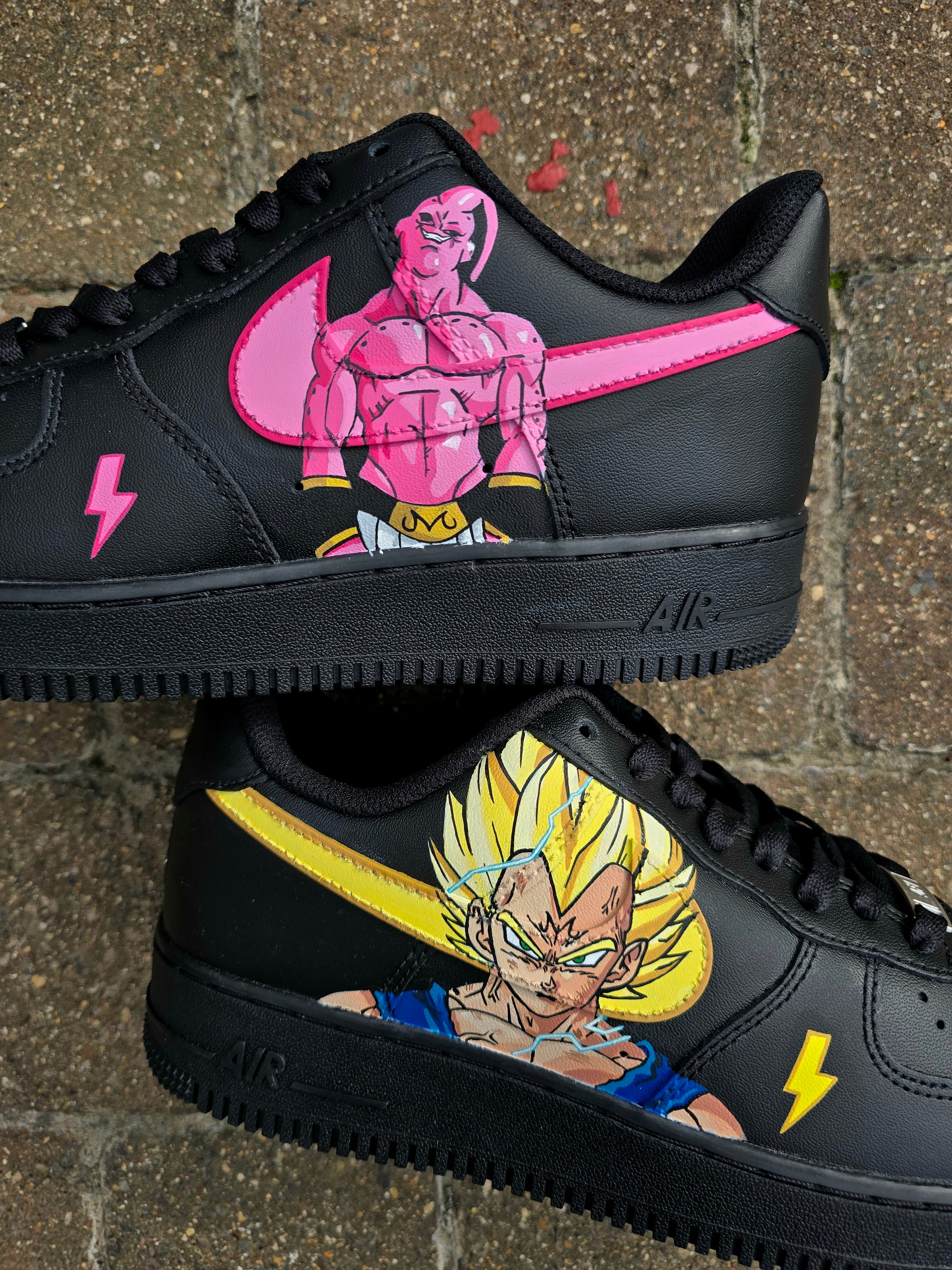 Custom Dragon Ball Z Nike Air Force 1 sneakers featuring hand-painted anime artwork of Majin Buu and Super Saiyan Goku. Black leather base with pink and yellow accents, lightning bolt details, and high-quality, waterproof custom paint job.

