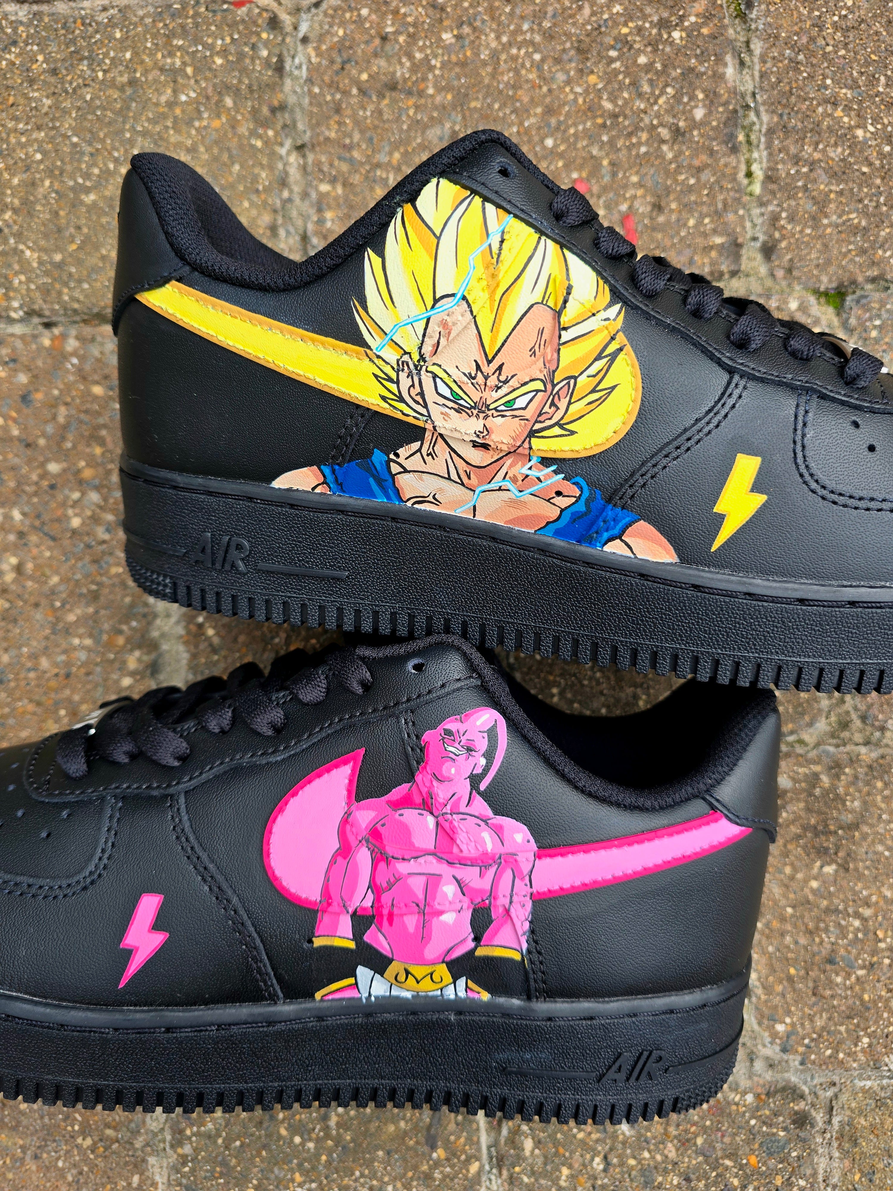 Custom Dragon Ball Z Nike Air Force 1 sneakers featuring hand-painted anime artwork of Majin Buu and Super Saiyan Goku. Black leather base with pink and yellow accents, lightning bolt details, and high-quality, waterproof custom paint job.

