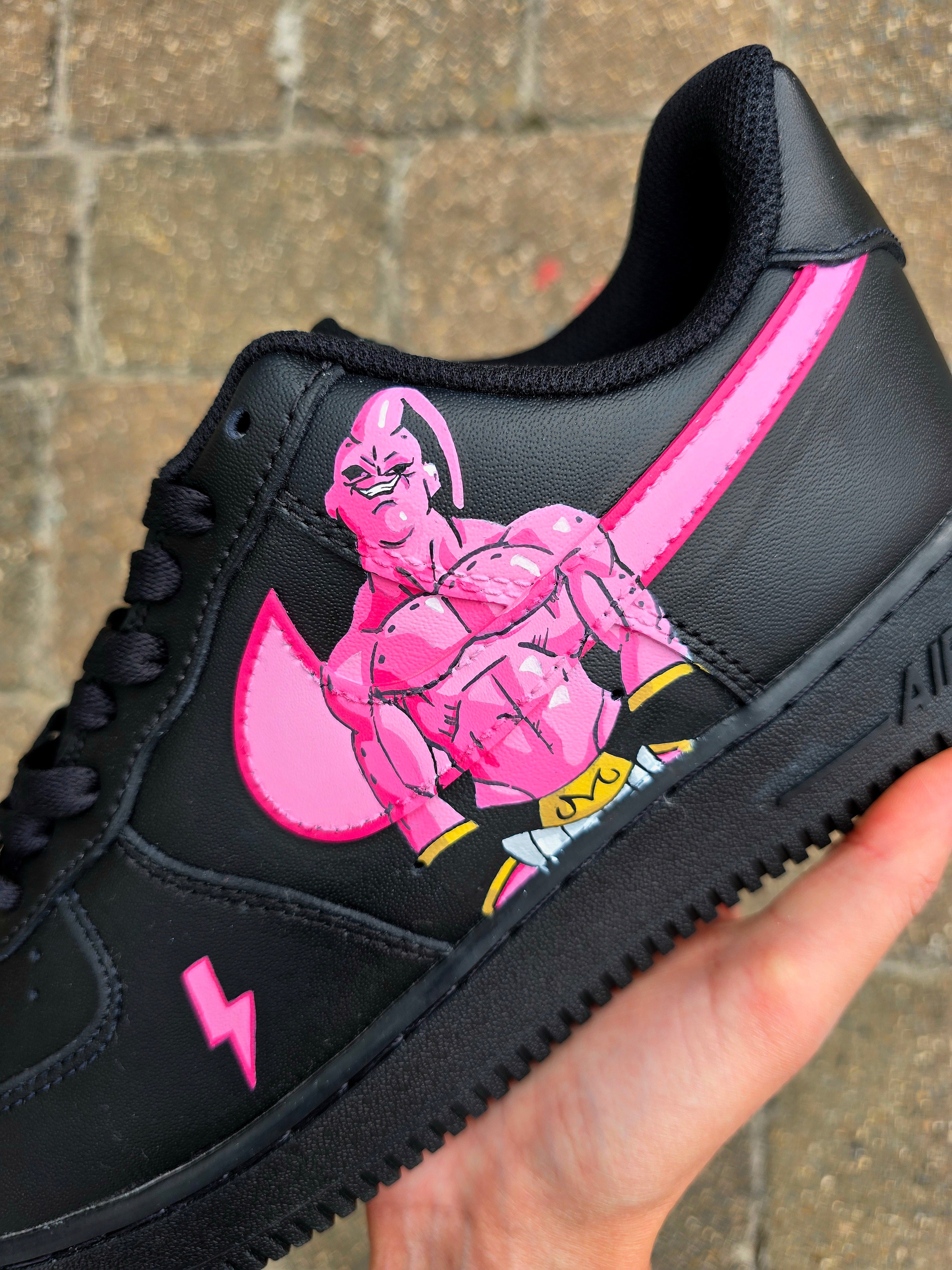 Custom Dragon Ball Z Nike Air Force 1 sneakers featuring hand-painted anime artwork of Majin Buu and Super Saiyan Goku. Black leather base with pink and yellow accents, lightning bolt details, and high-quality, waterproof custom paint job.

