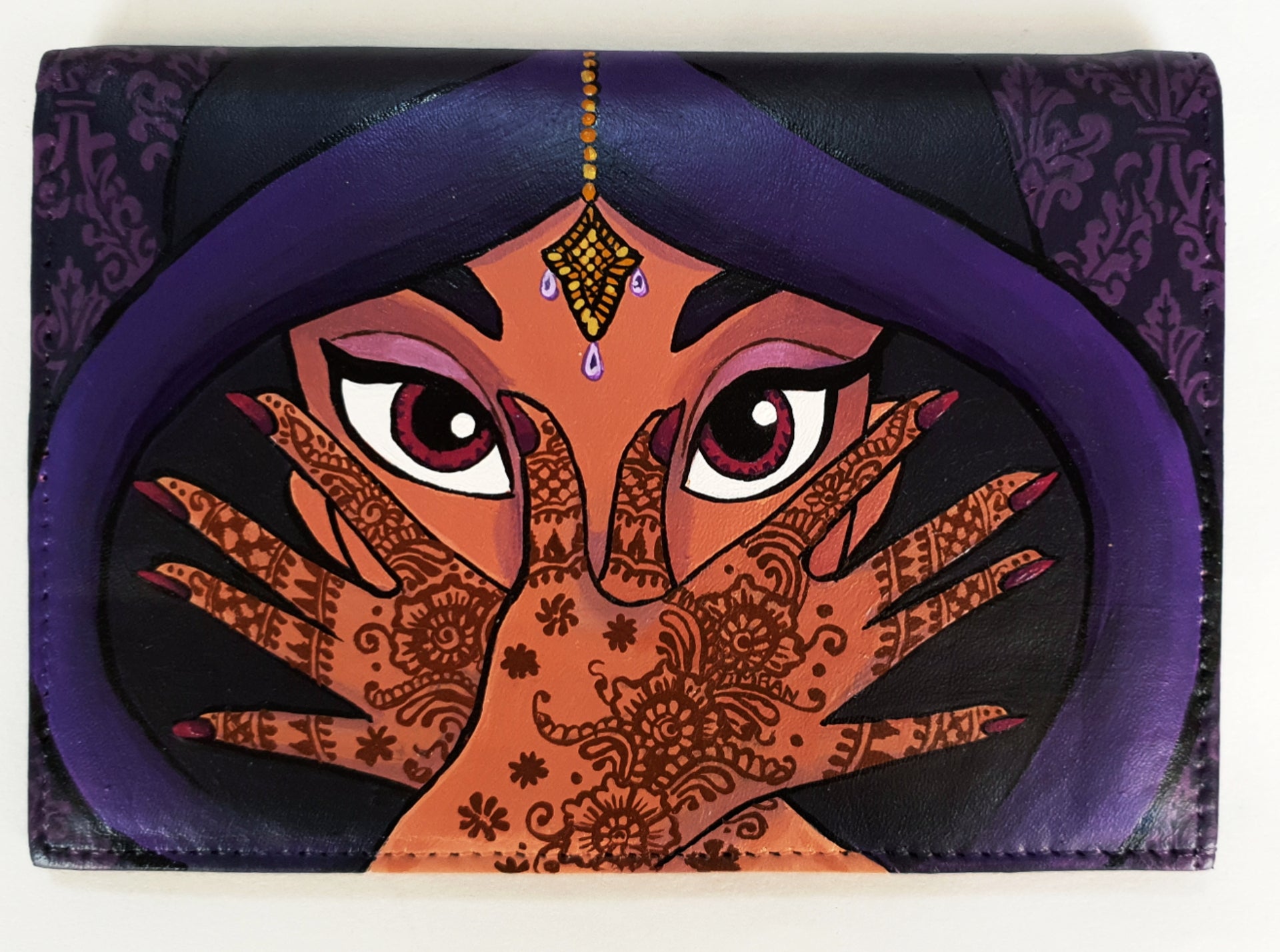 A hand-painted leather wallet featuring a custom portrait of a person, pet, or loved one. The painting is detailed, colourful, and made using premium-quality waterproof leather paints. Ideal for gifting or personal keepsakes, this wallet showcases artistic craftsmanship and premium leatherwork.

