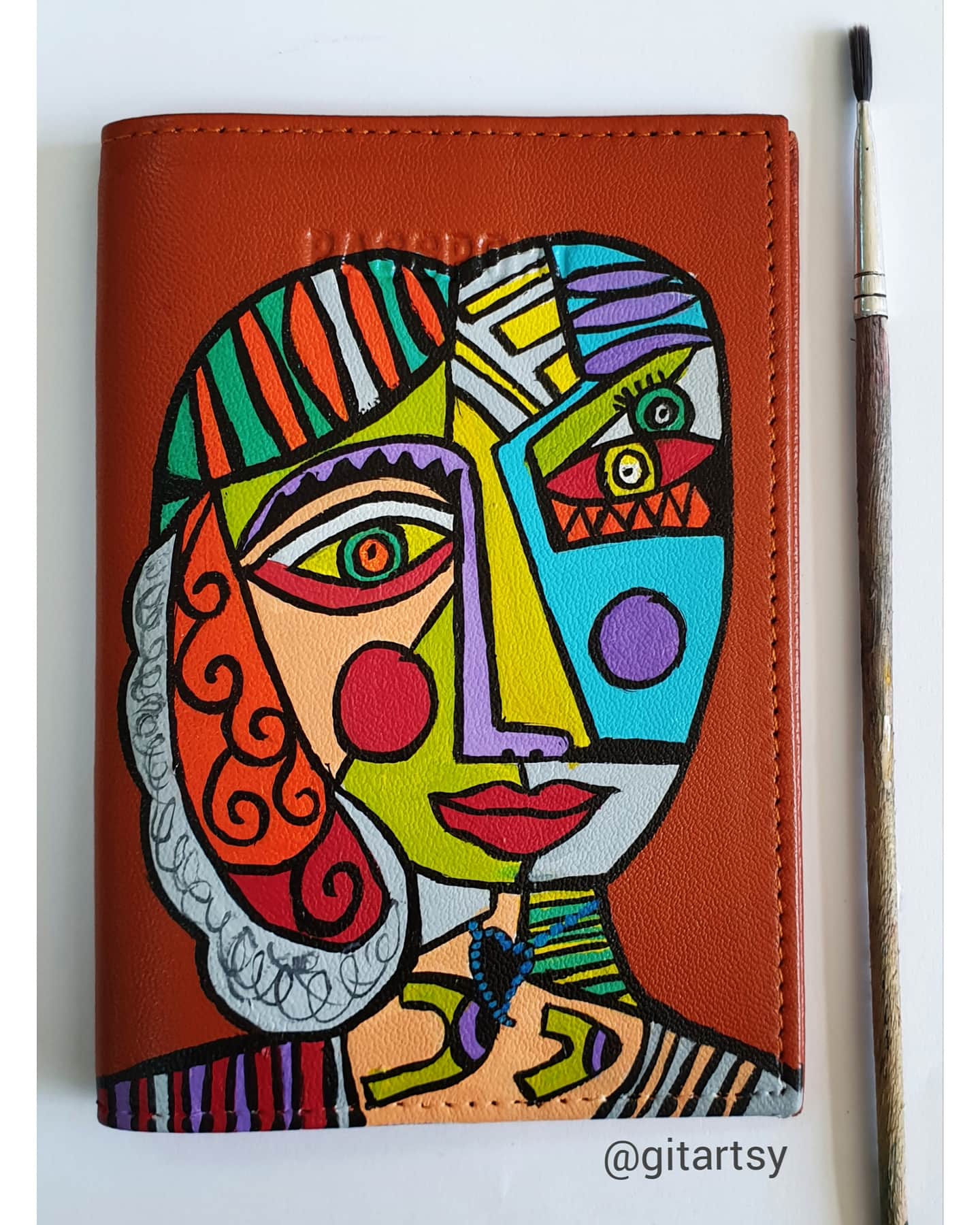 A hand-painted leather wallet featuring a custom portrait of a person, pet, or loved one. The painting is detailed, colourful, and made using premium-quality waterproof leather paints. Ideal for gifting or personal keepsakes, this wallet showcases artistic craftsmanship and premium leatherwork.

