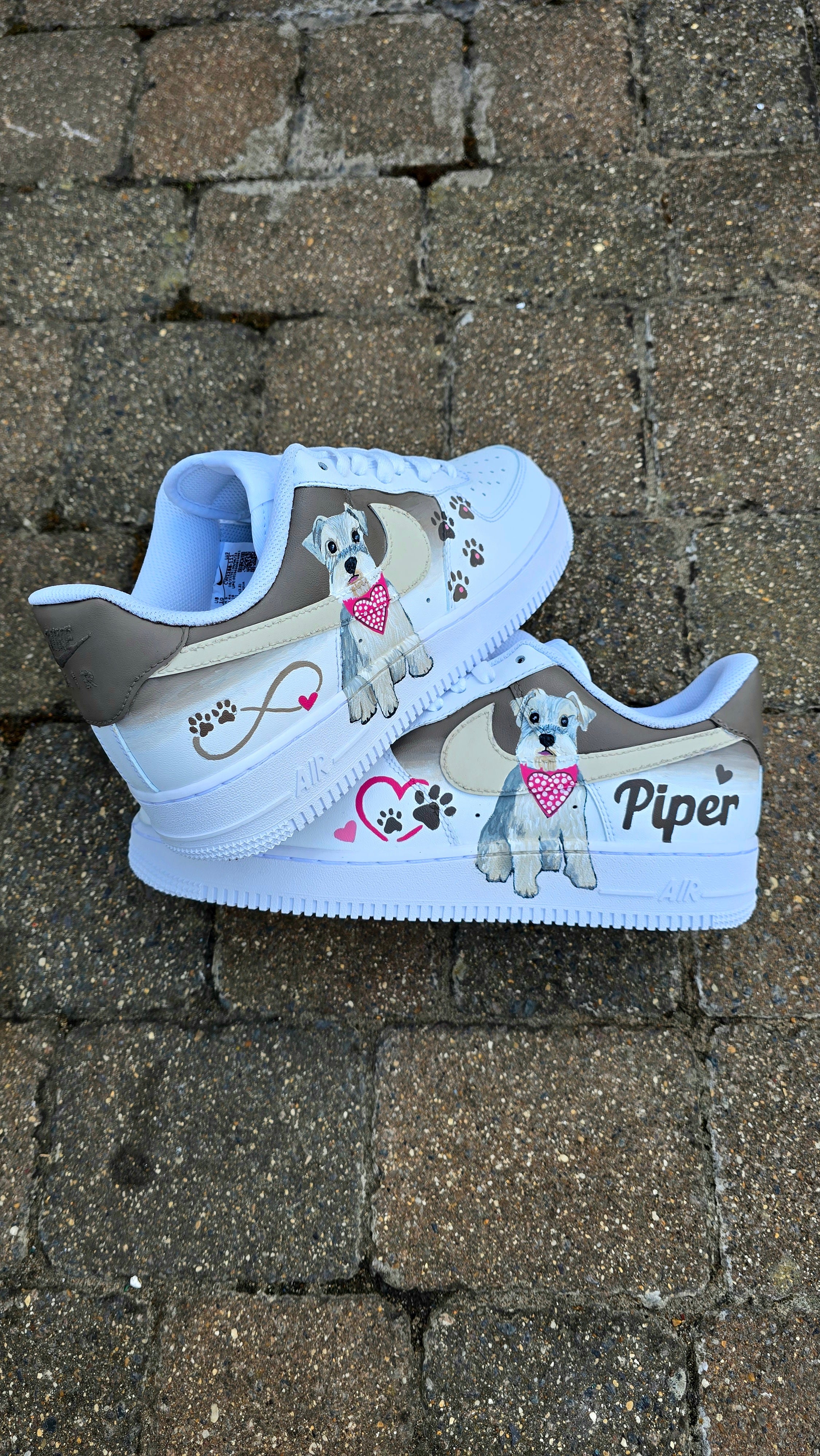 Hand-painted Nike Air Force 1 custom sneakers featuring a realistic pet portrait of “Piper” the dog 🐾, pink or taupe background, heart ❤️ and paw print accents, and personalised name detail, created by Gitartsy.

