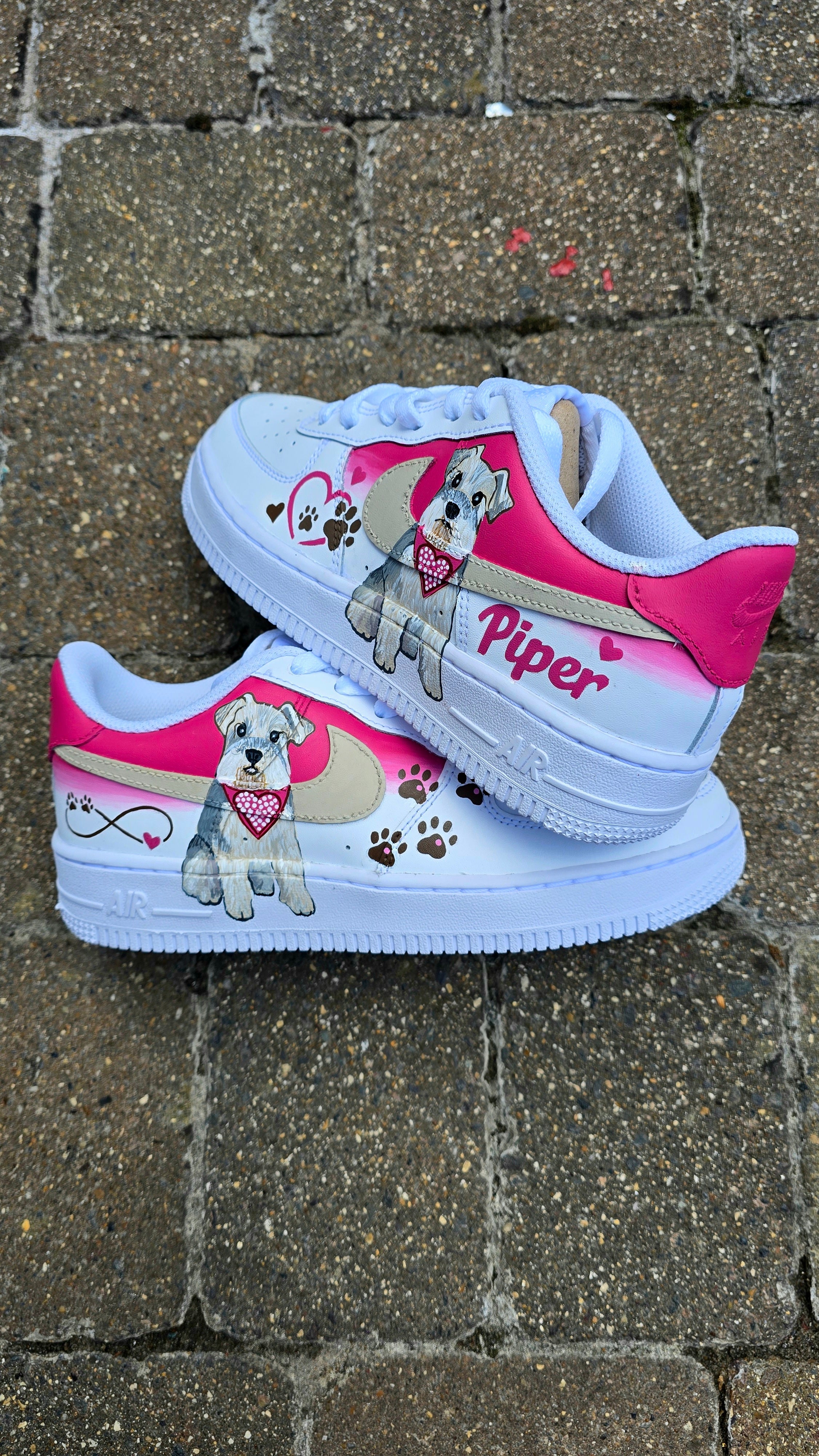 Hand-painted Nike Air Force 1 custom sneakers featuring a realistic pet portrait of “Piper” the dog 🐾, pink or taupe background, heart ❤️ and paw print accents, and personalised name detail, created by Gitartsy.

