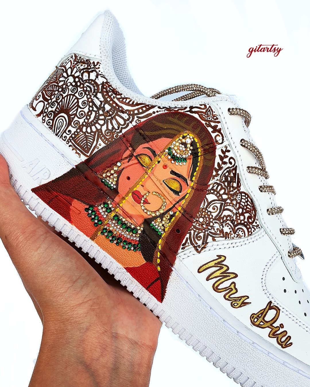 Indian bride portrait custom Nike AF1 sneakers with henna designs - hand painted for weddings and brides. The sneaker illustrate a beautiful indian bride in red lehenga, a henna background and a brides hand with choora made of crystals 