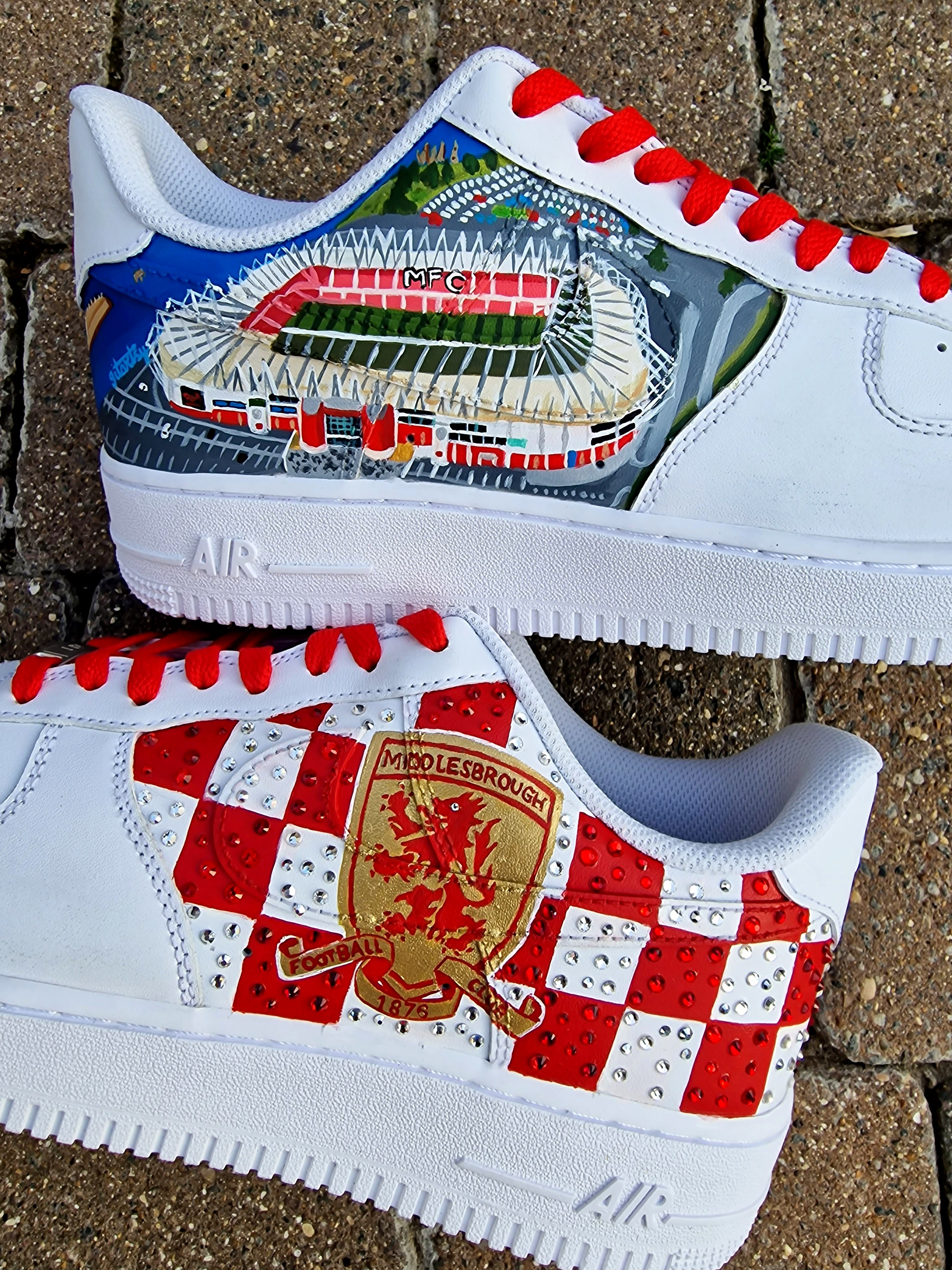 Custom hand-painted sneakers featuring Middlesbrough FC crest, red-and-white checkered pattern with stud embellishments, and detailed Riverside Stadium artwork. White base sneakers with red laces, designed by Gitartsy for football fans, sneaker collectors, and Boro supporters.

