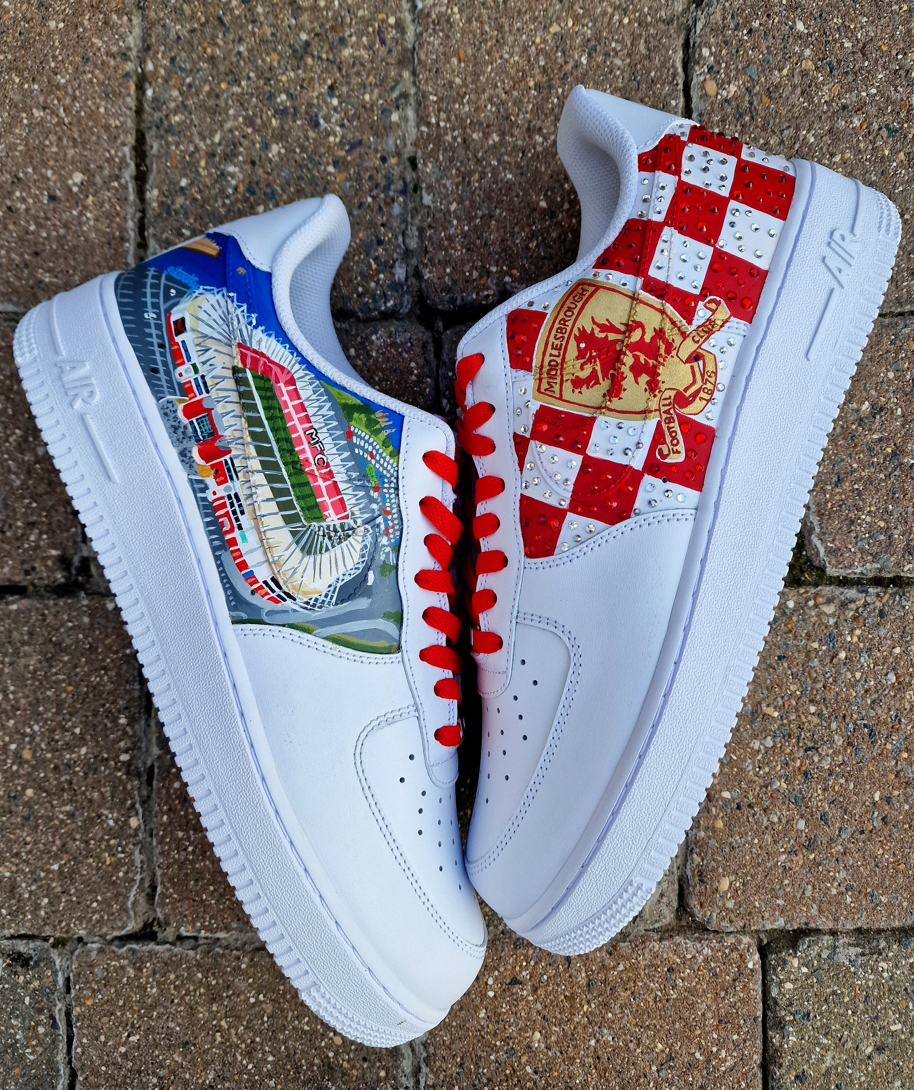 Custom hand-painted sneakers featuring Middlesbrough FC crest, red-and-white checkered pattern with stud embellishments, and detailed Riverside Stadium artwork. White base sneakers with red laces, designed by Gitartsy for football fans, sneaker collectors, and Boro supporters.

